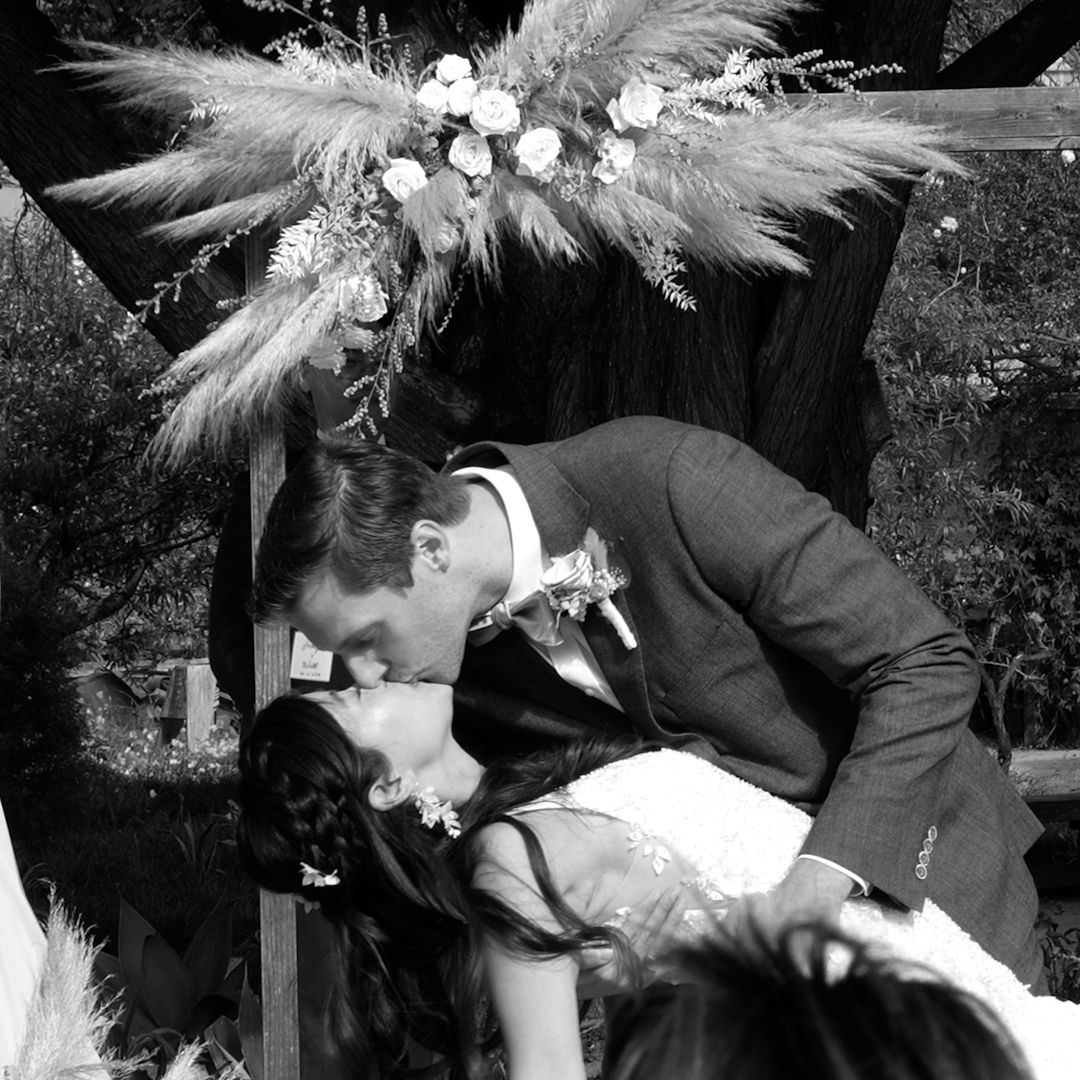 Black and white photo series showing a couple in formal attire sharing intimate moments in a garden setting.