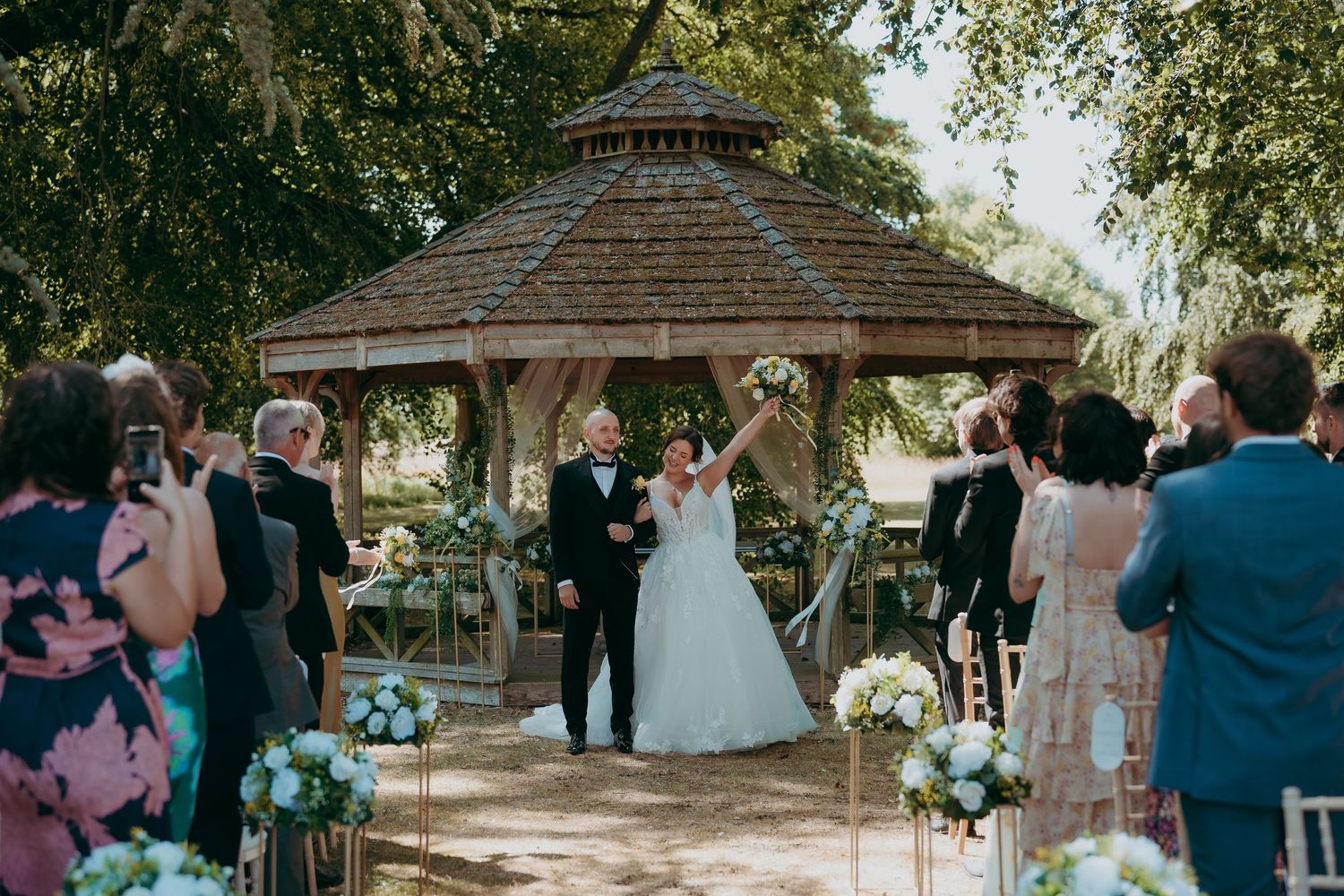 Outdoor wedding ceremony at Irnham Hall on a sunny July day