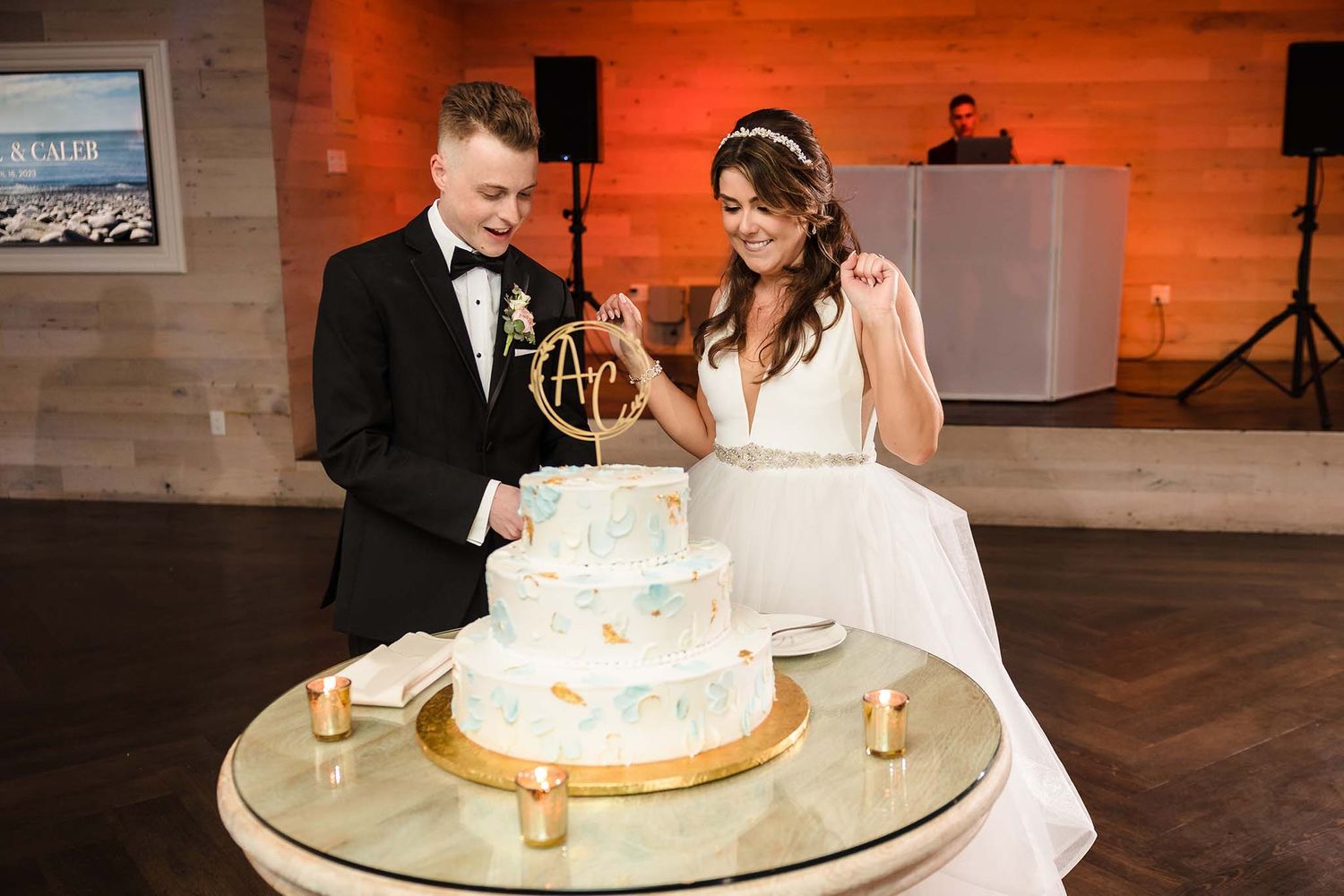 The bride and groom eagerly anticipate cutting their wedding cake.