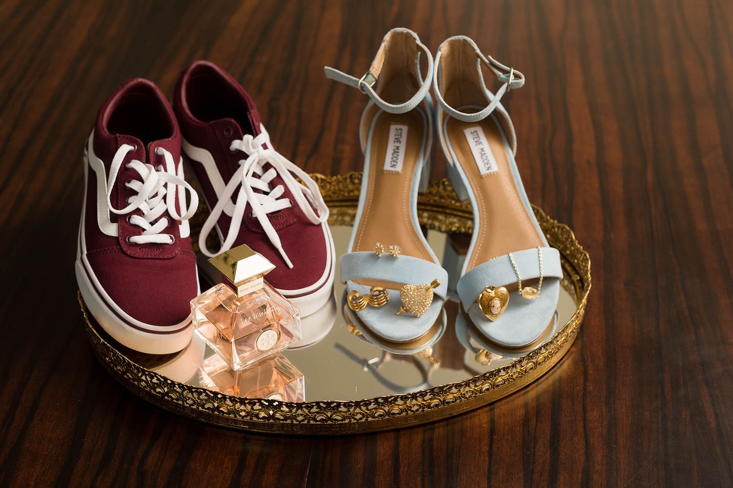 Bride's details including shoes, jewelry, and perfume bottle.
