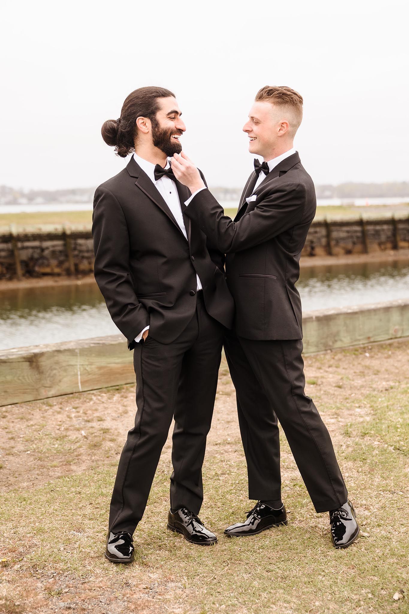 The groom and a groomsmen share a funny moment on the wedding day.