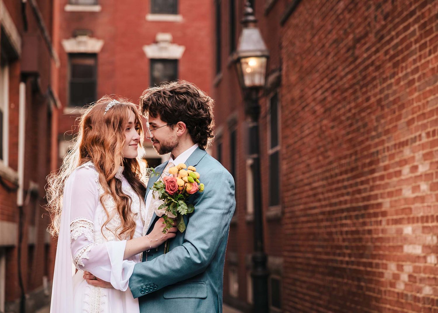 The bride and groom embrace and look into each other's eyes during a private moment on their chilly winter Boston wedding day.
