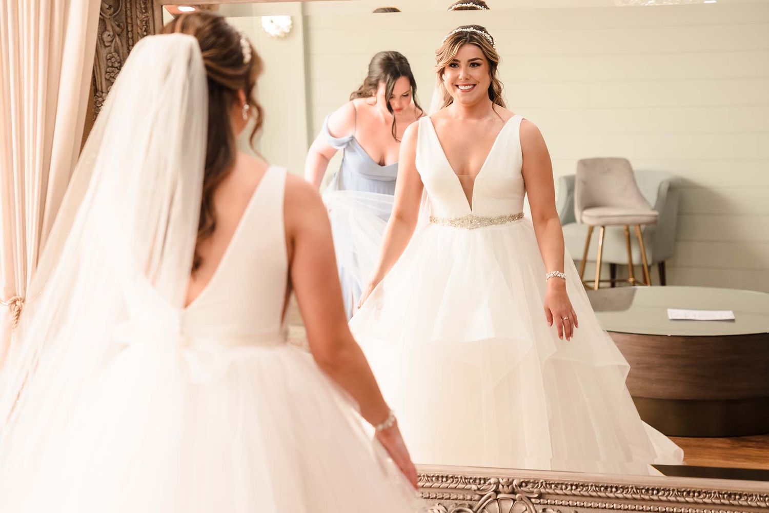 THe bridesmaids made sure the bride is perfect for the wedding ceremony.