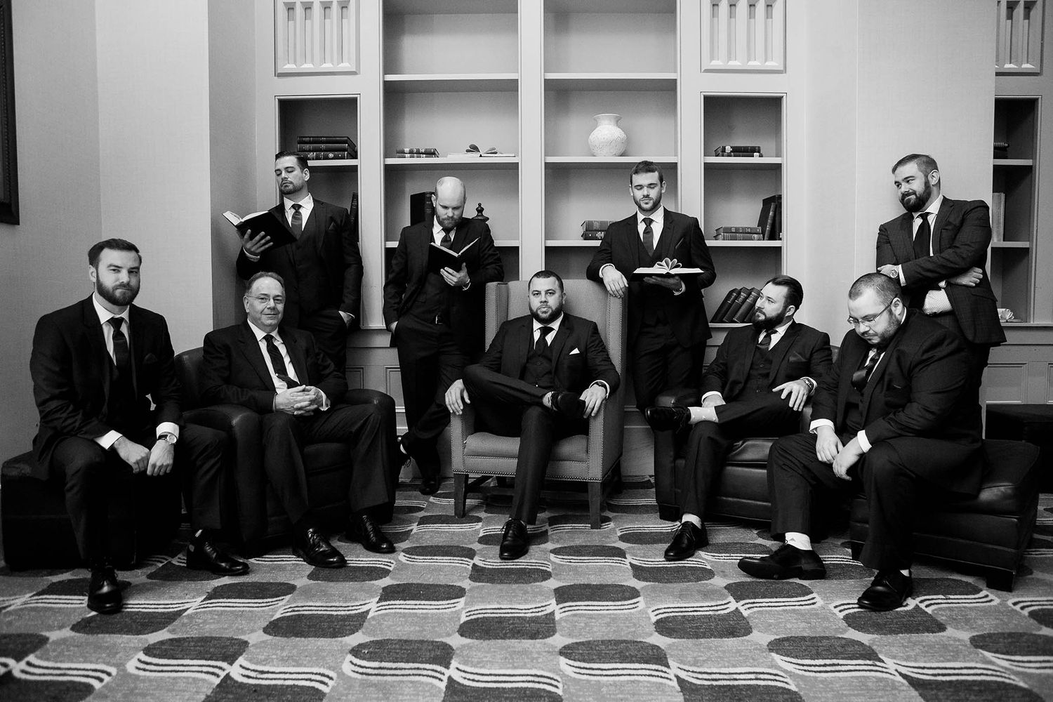 The groom and his groomsmen pose for a dramatic and serious portrait.
