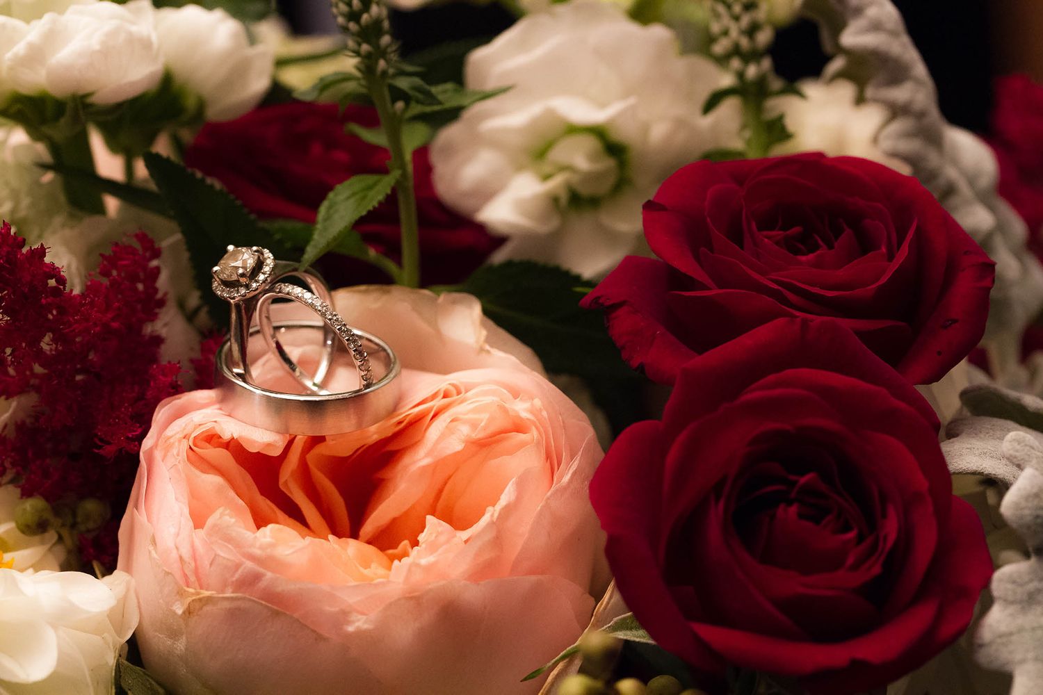 Detail shot of the wedding rings and flowers.
