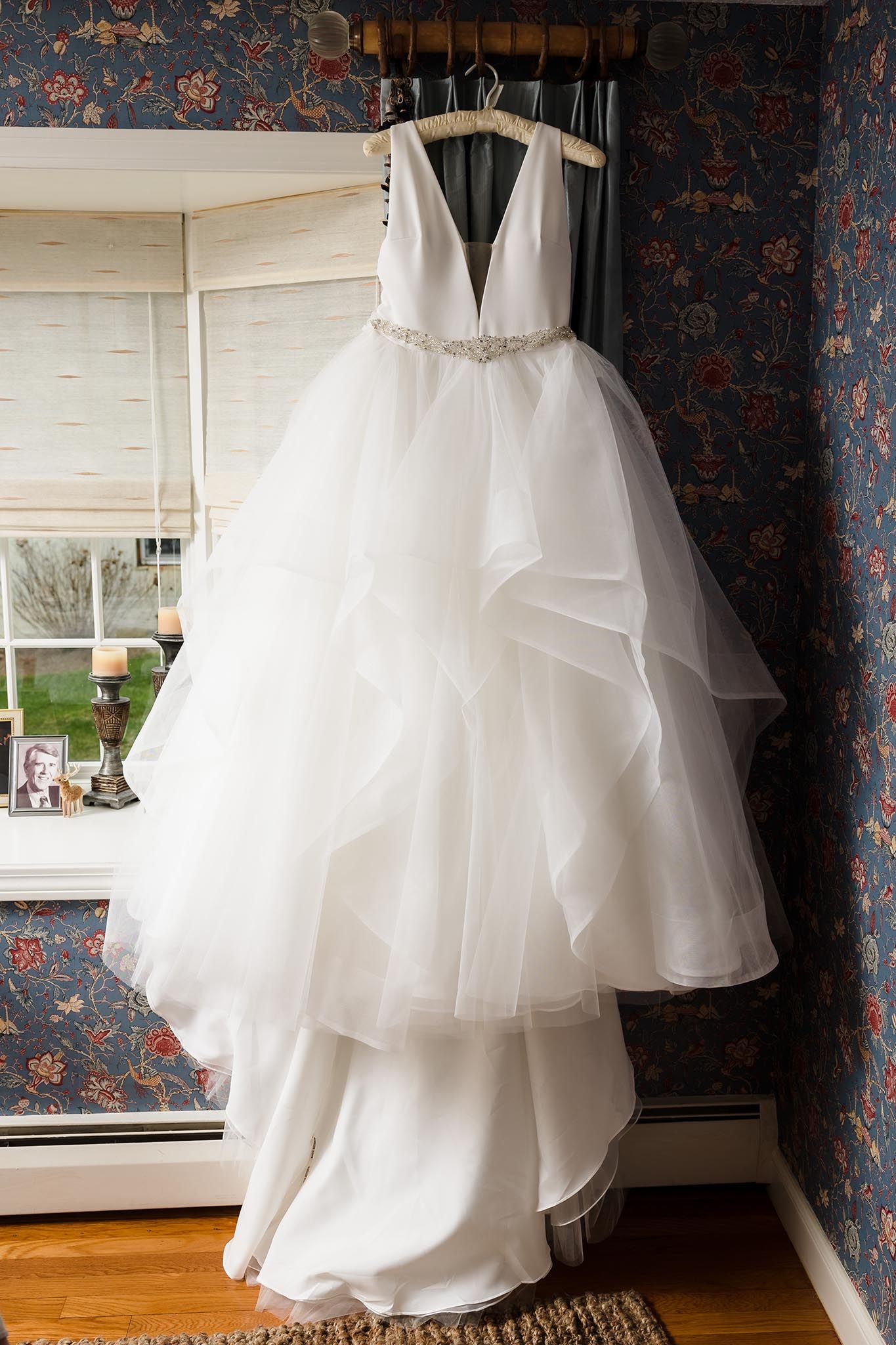 A beautiful wedding dress hanging up for all to see right before the wedding at the Oceanview of Nahant