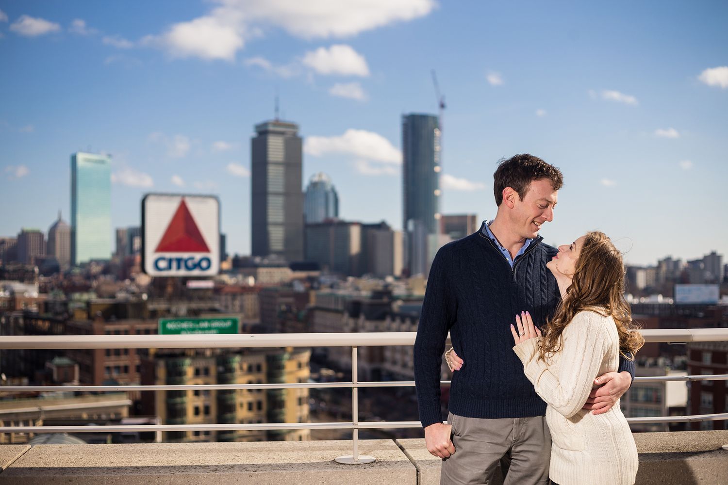 The bride and groom looking into each other's eye on the rooftop portrait over looking Fenway Park.