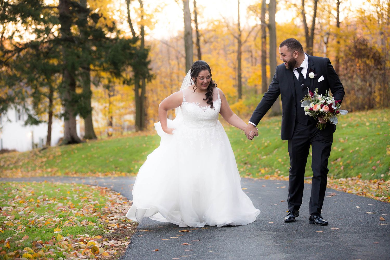 A funny laugh between the newly married bride and groom take a stroll around Peirce Farm and share a laugh,.