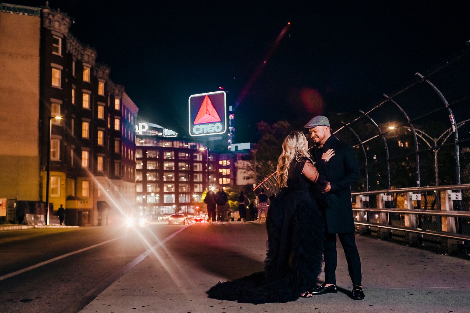 A dramatic nighttime engagement session on the highway in front of Fenway Park