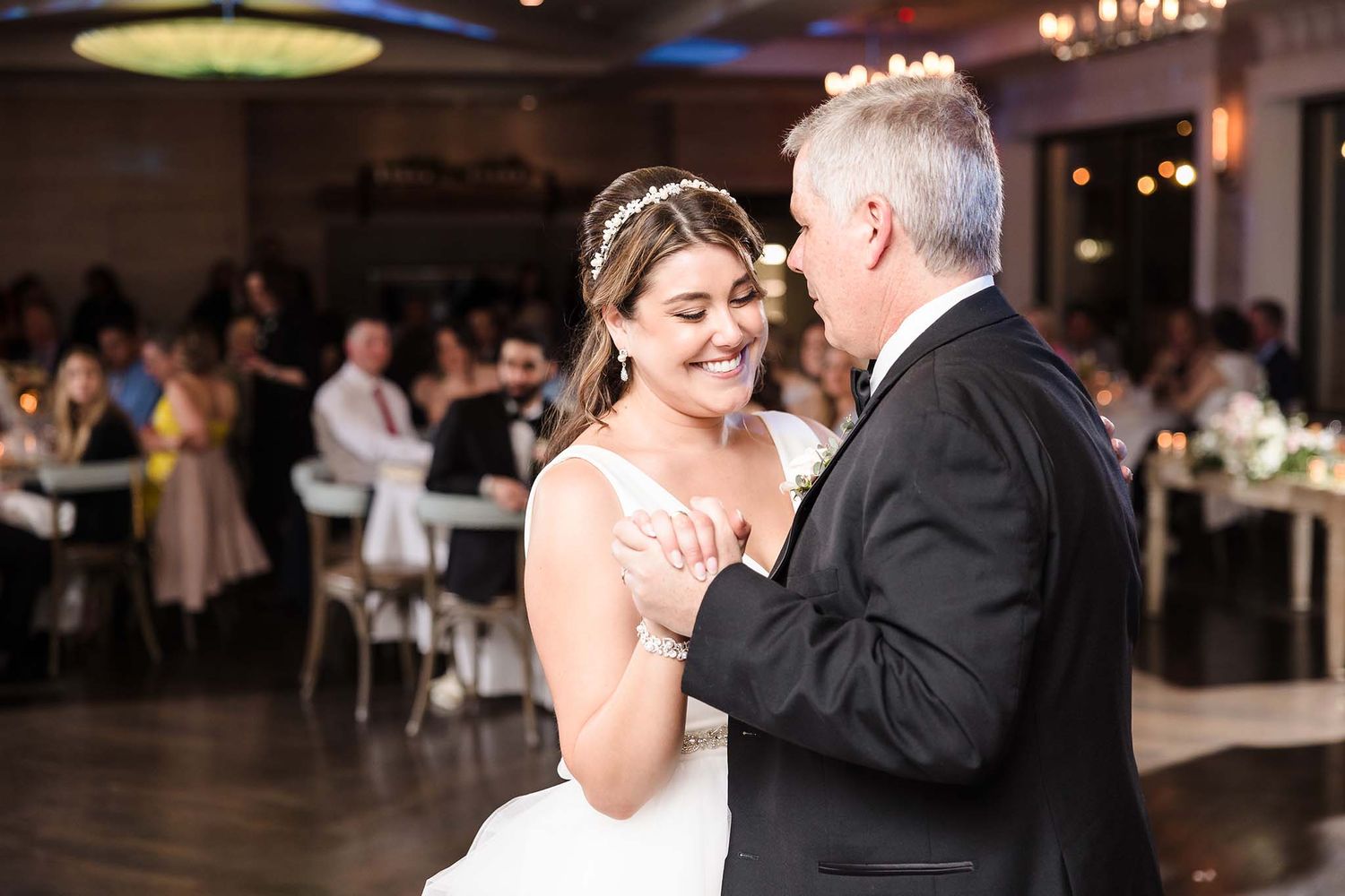 The bride and her father enjoy  their dance.