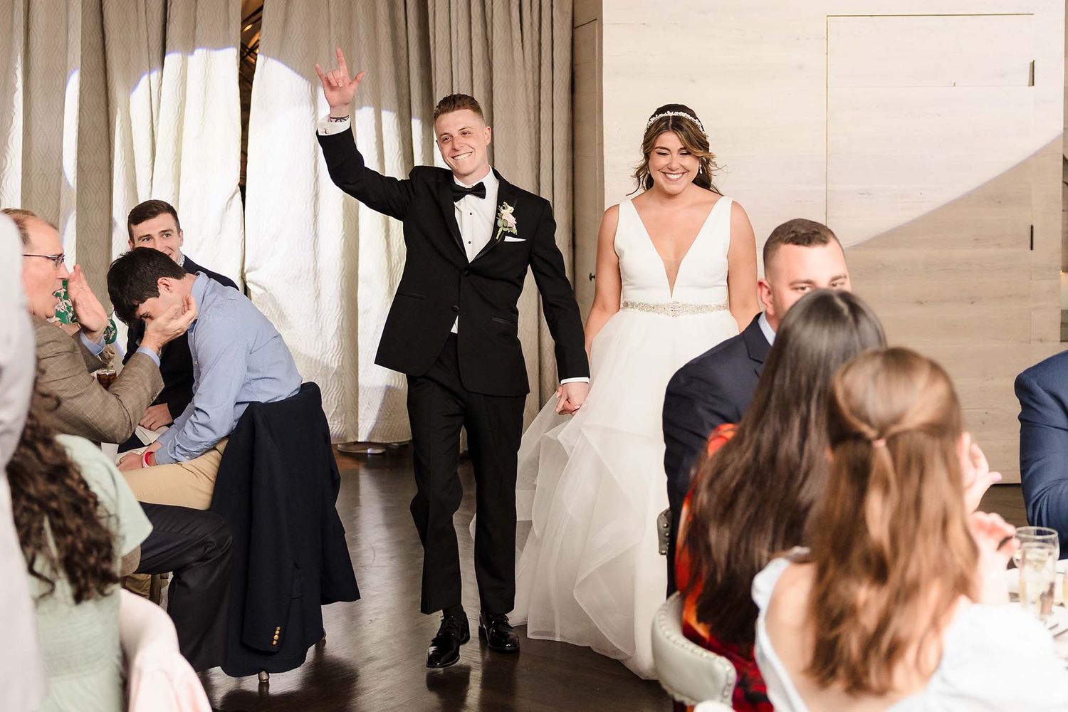 Photography of bride and groom being announced to their wedding reception.