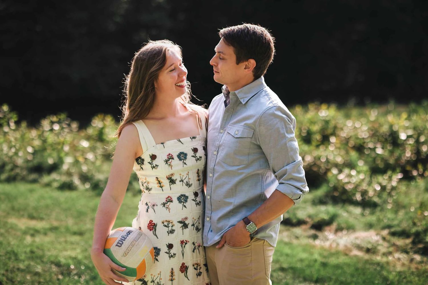 Couple standing close together in a vineyard, gazing at each other with affection. Engagement at Borderland State Park, North Easton, MA