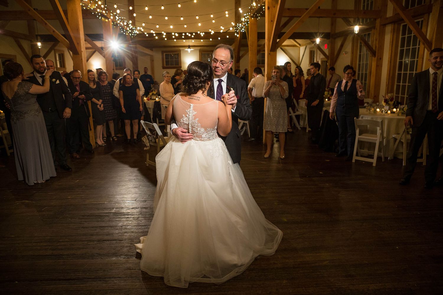 The bride and her father enjoy a dance together.
