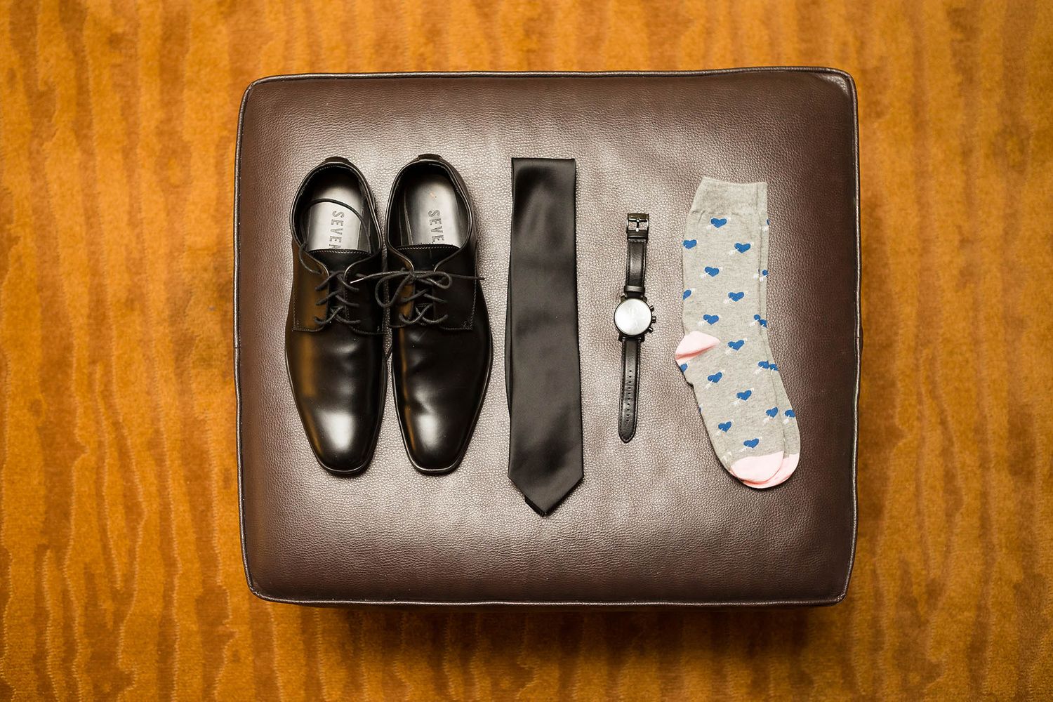 Groom's details including shoes, tie, watch, and socks.