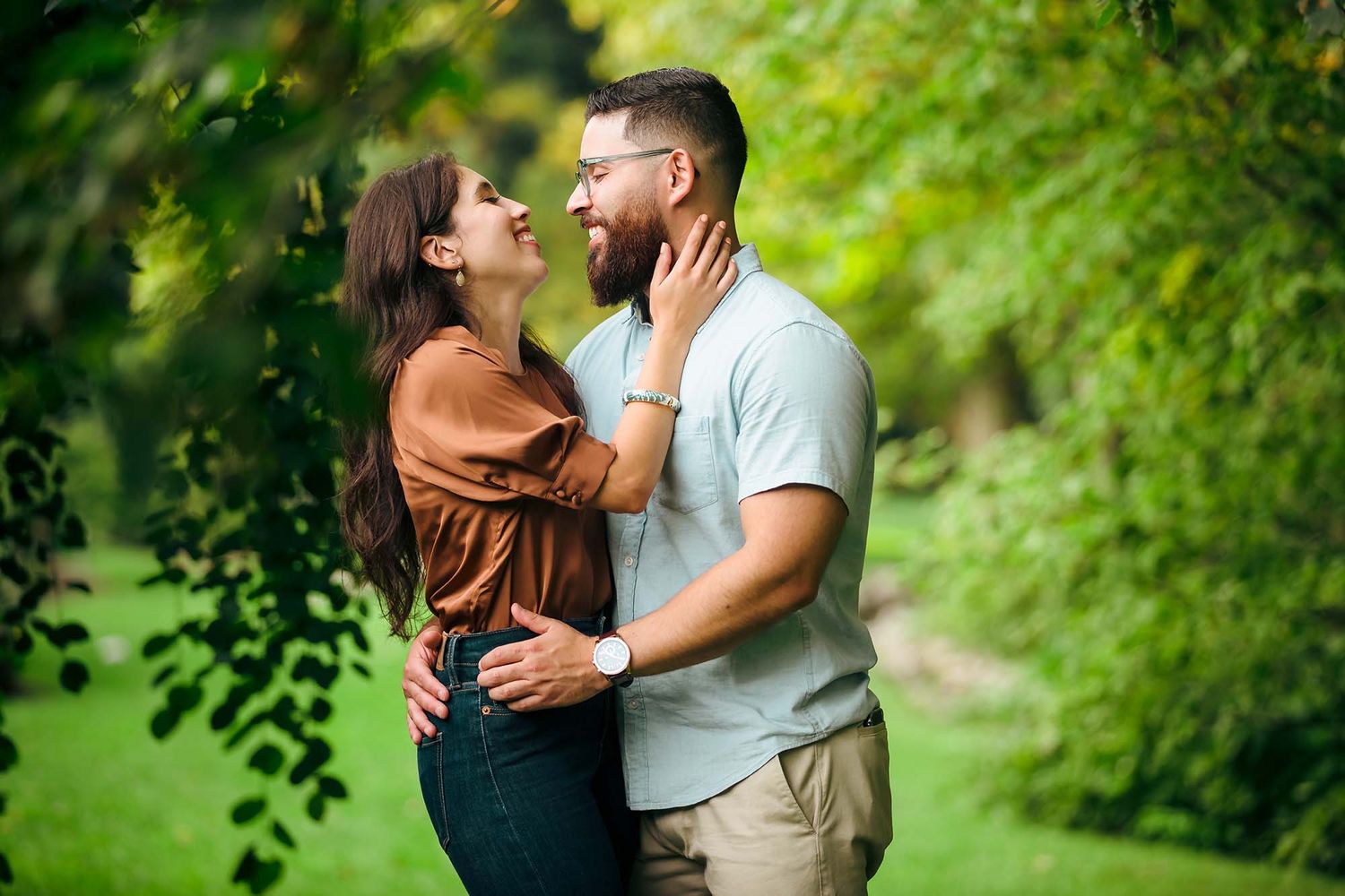 Couple enjoying a passionate kiss in the park during their engagement session