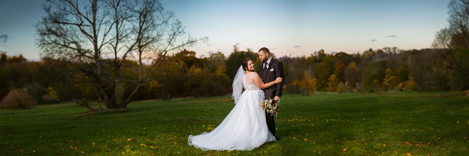A dramatic Portrait of the bride and groom at the pasture at Peirce Farm Witch Hill
