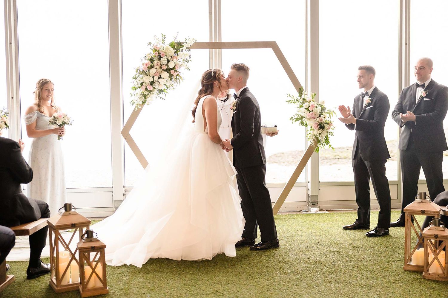 THe bride and groom share their first kiss as man and wife at the end of the wedding ceremony at the Oceanview of Nahant
