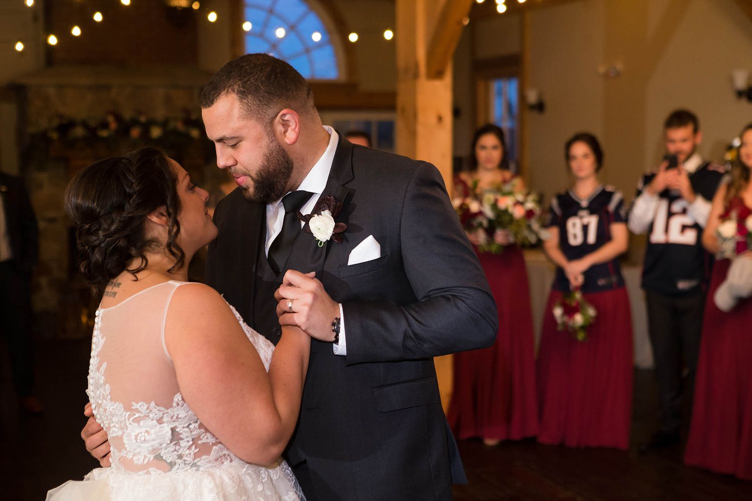The bride and groom look into each other's eyes during their first dance.