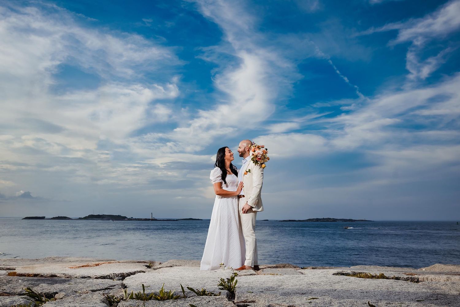 The bride and groom smile at each other after their wedding ceremony in the city of Hull Massachuttres