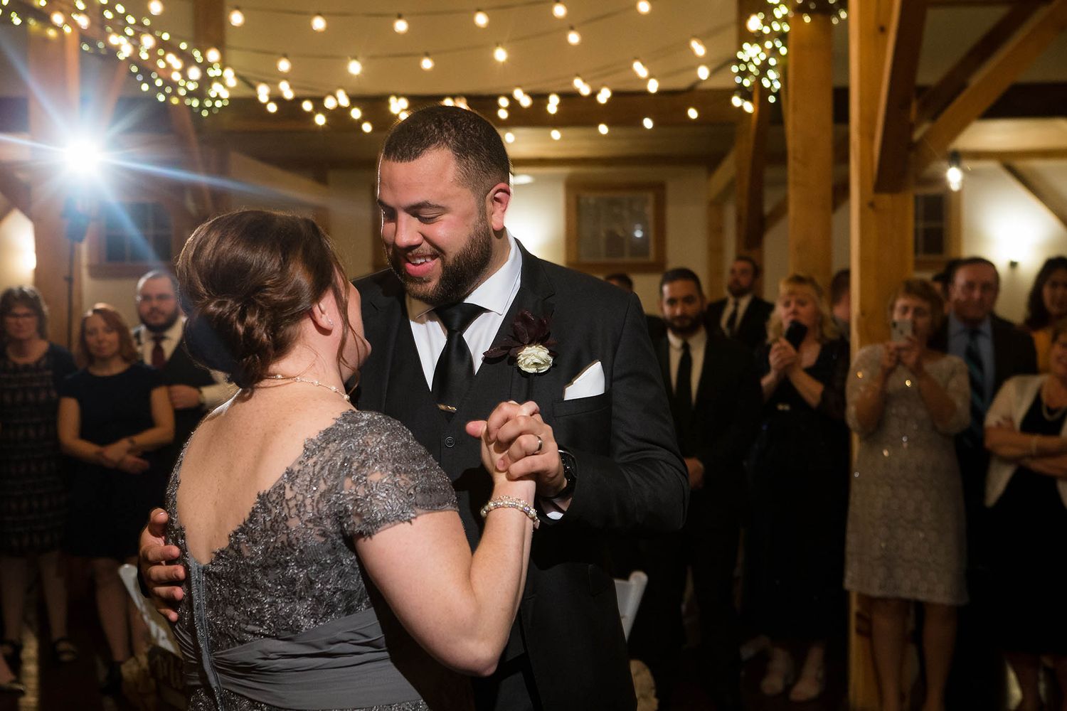 The groom shares a dance with his mother during the wedding reception.