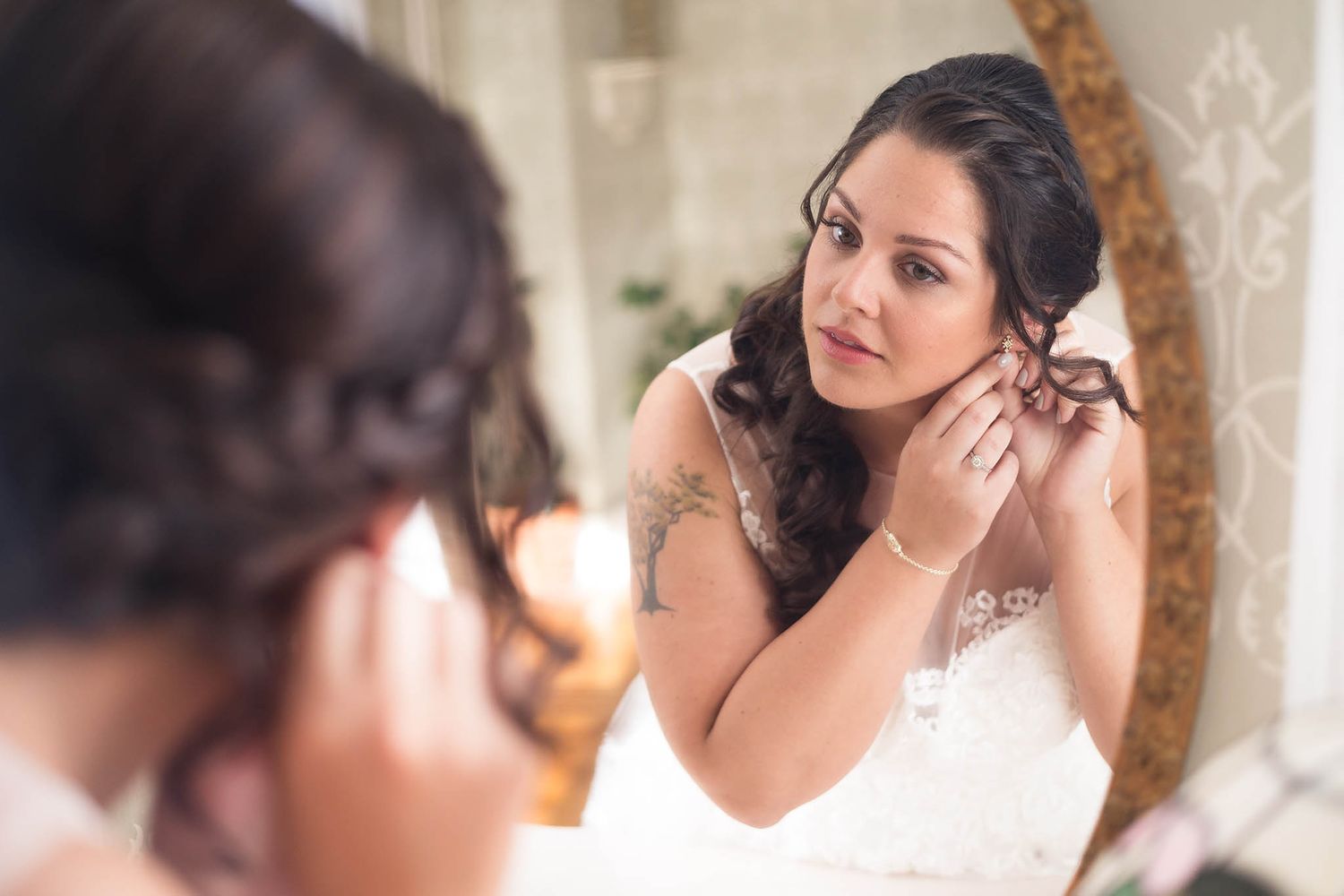Bride puts on her jewelry in the bridal suite at Peirce Farm