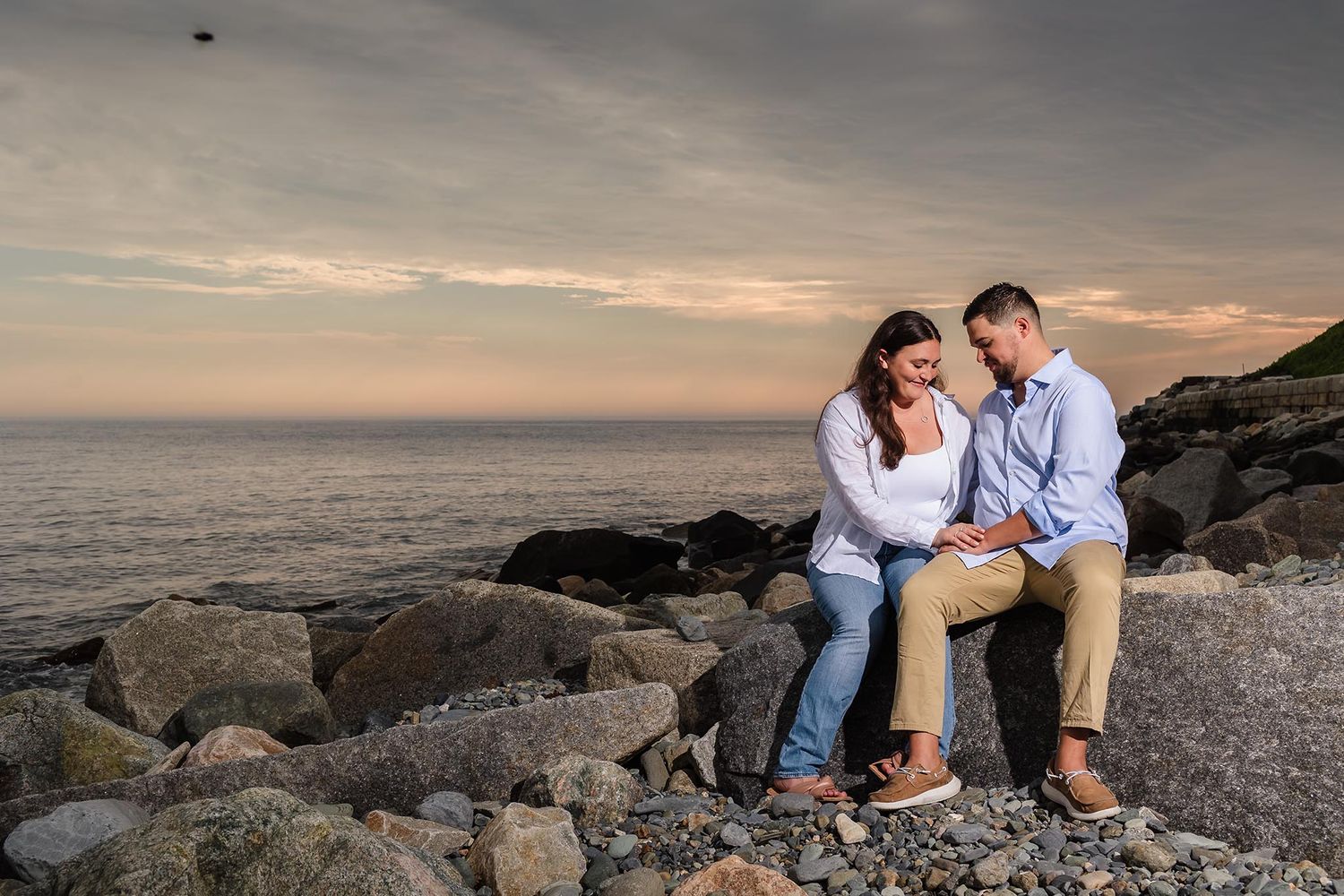 The couple pause on their engagement session to think about their love while enjoying a view of the Atlantic ocean.