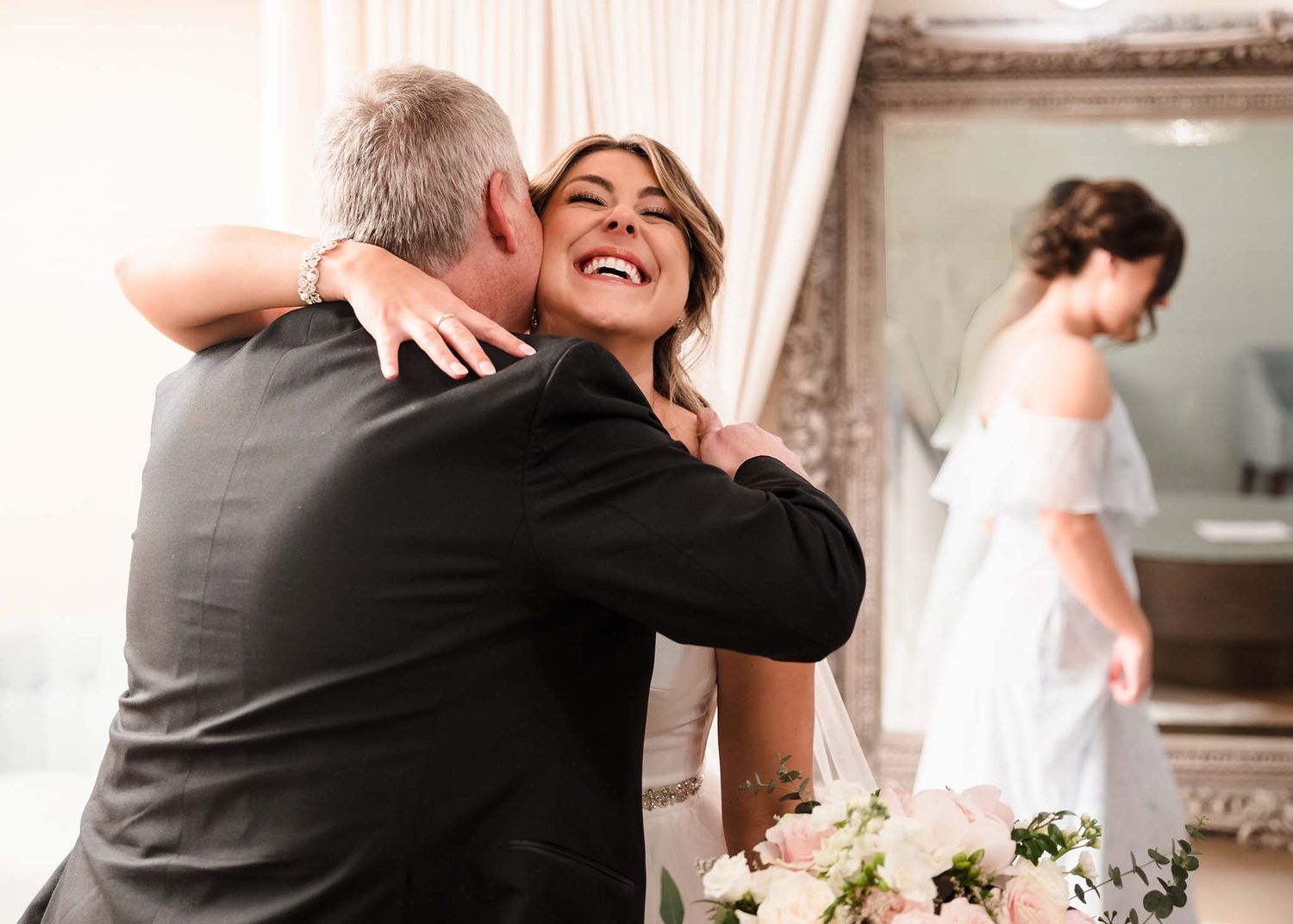 THe bride and her father share a big affectionate hug right before the wedding ceremony.