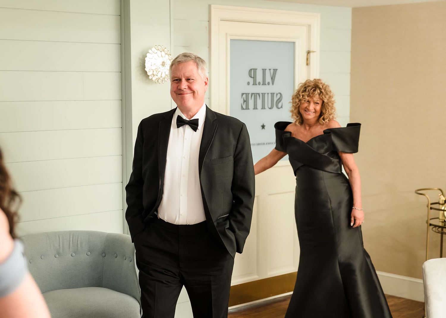 The father of the bride sees his daughter for the first time in her wedding dress inside the bridal suite of the Oceanvi