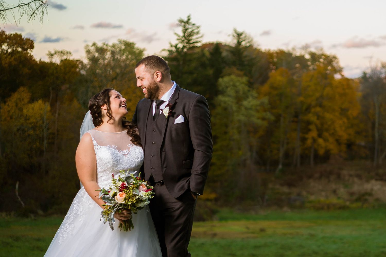 The bride and groom share a laugh on their wedding day.