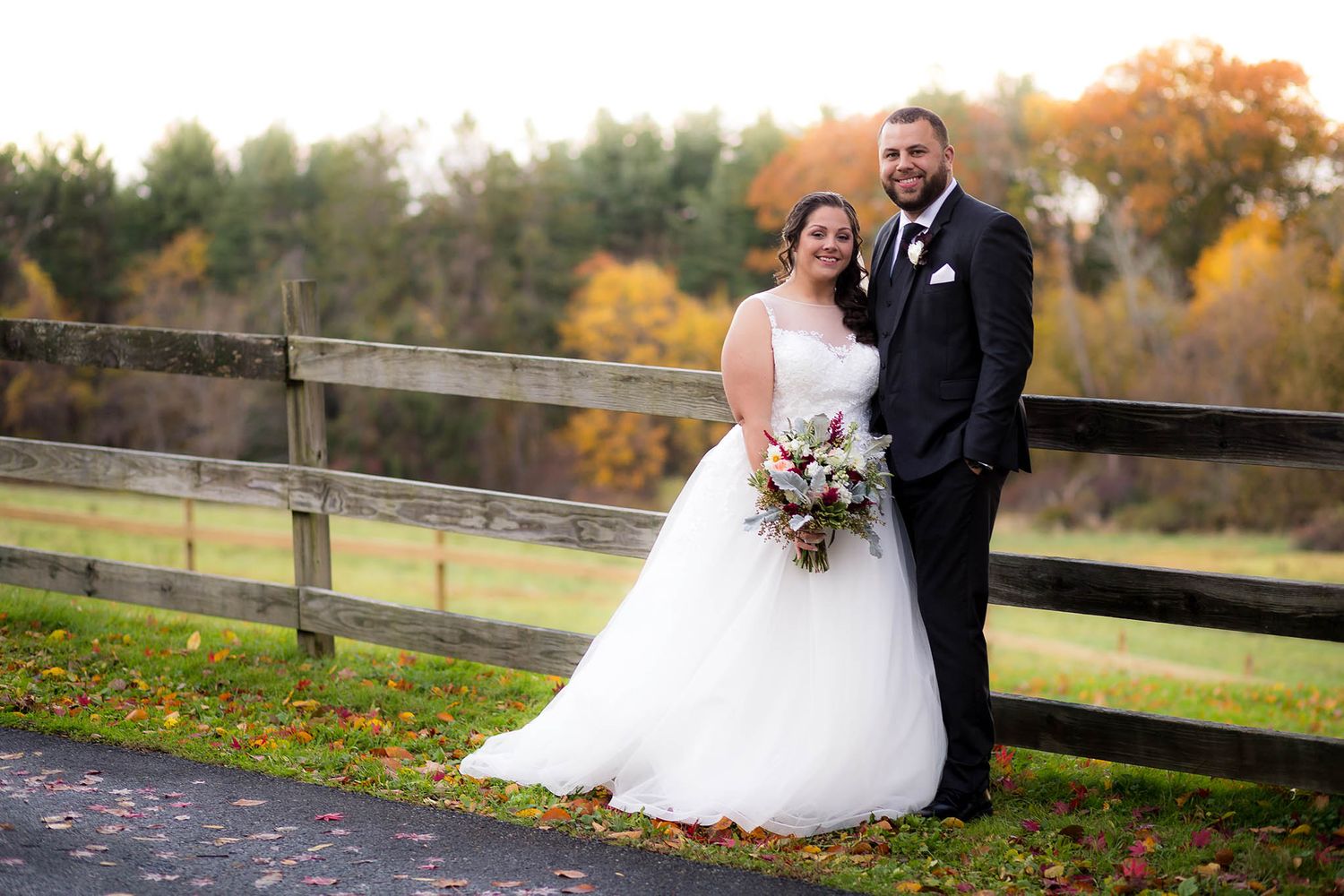 The newly married bride and groom pose for a portrait on the grounds of Pierce Farm at Witch Hill