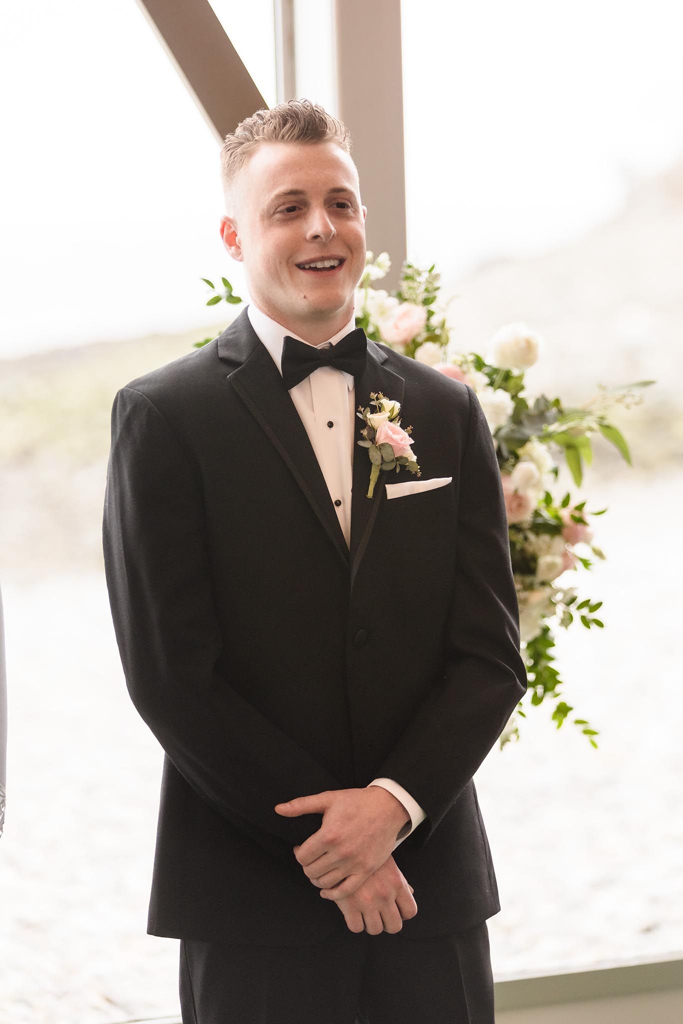 THe groom sheds a tear as he looks down the isle and see his bride in her wedding dress for the first time.