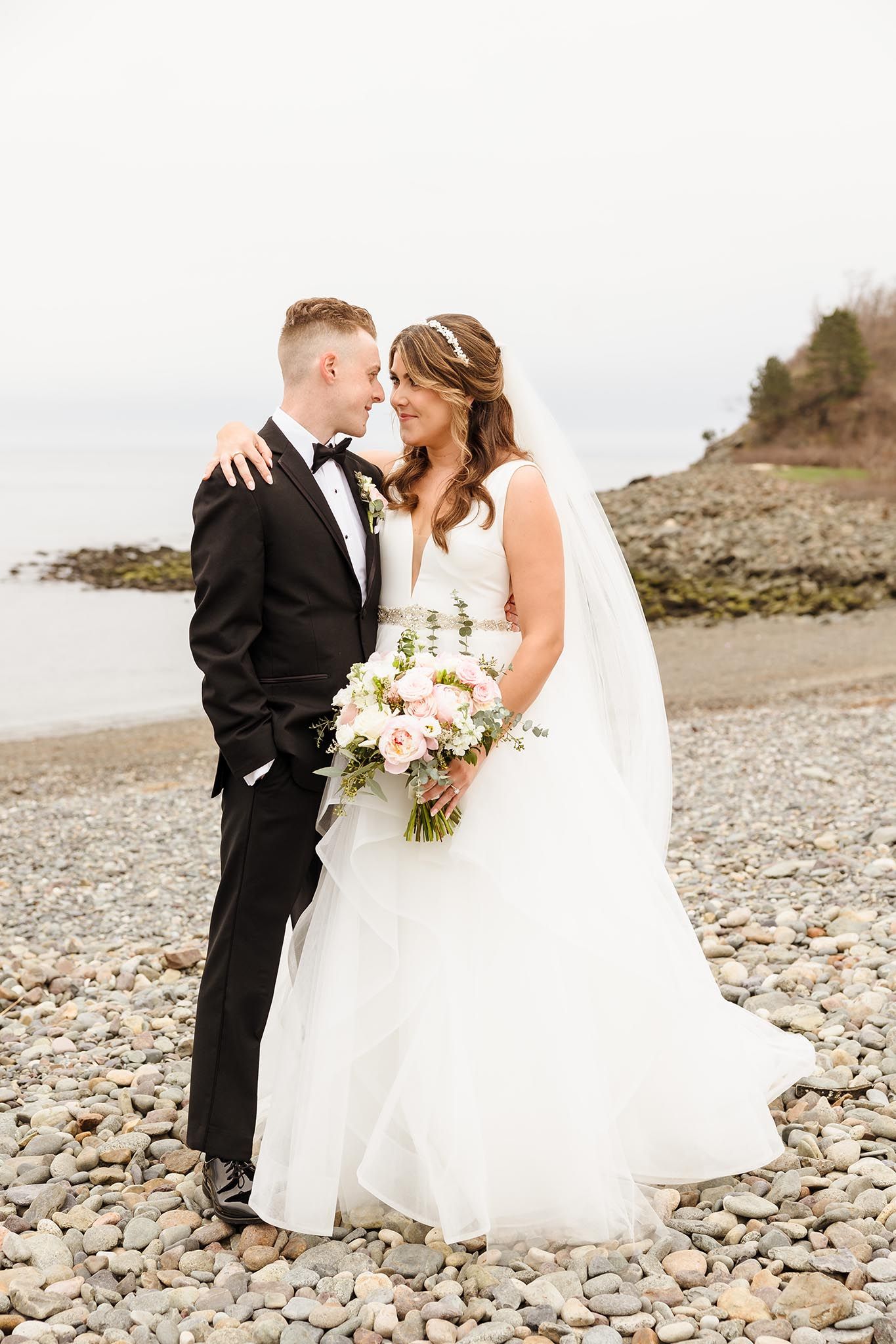 The bride and groom enjoy a romantic moment outside the oceanview.
