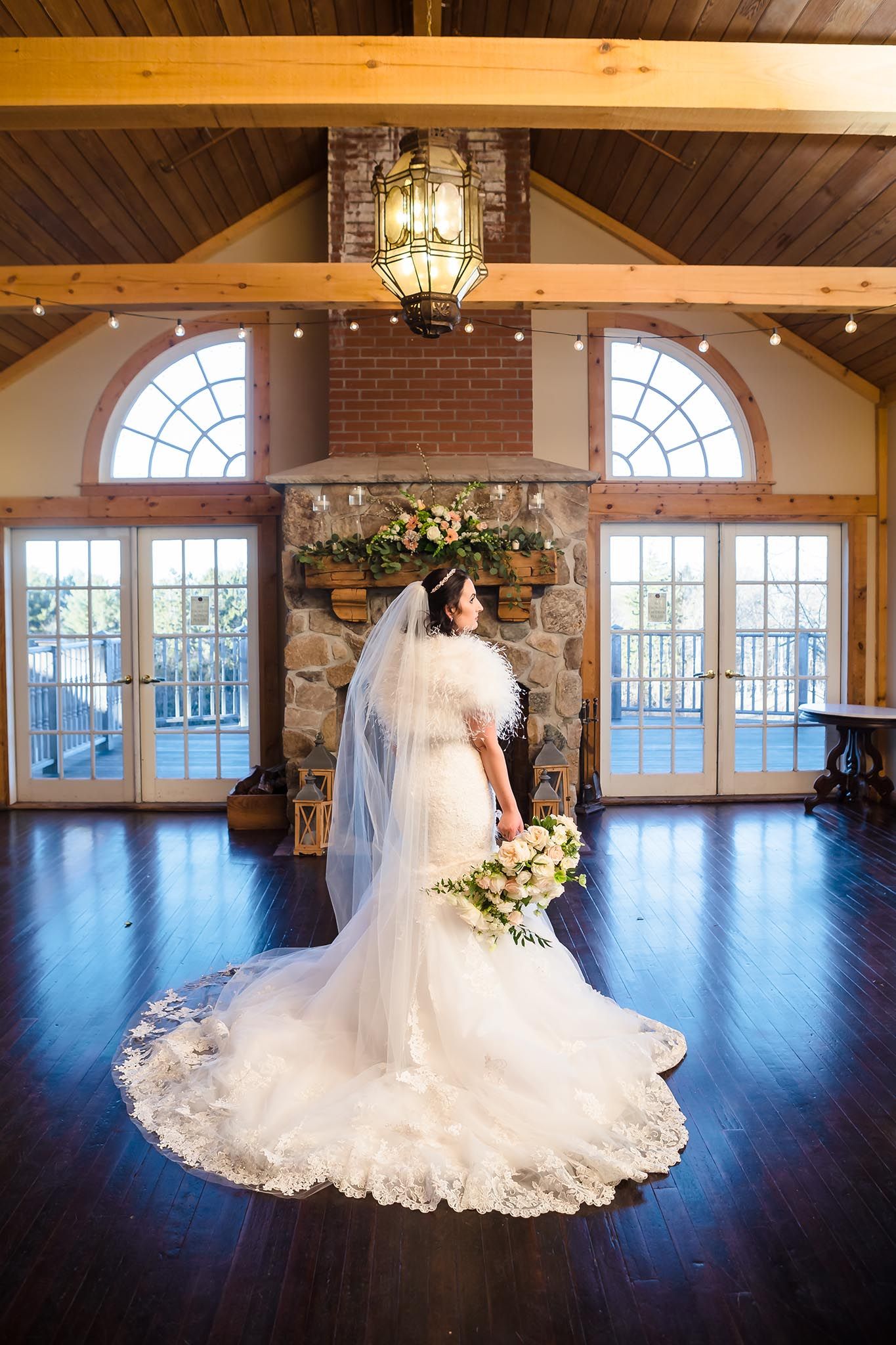 The bride takes a dramatic pose for this formal portrait in the barn at Peirce Farm.