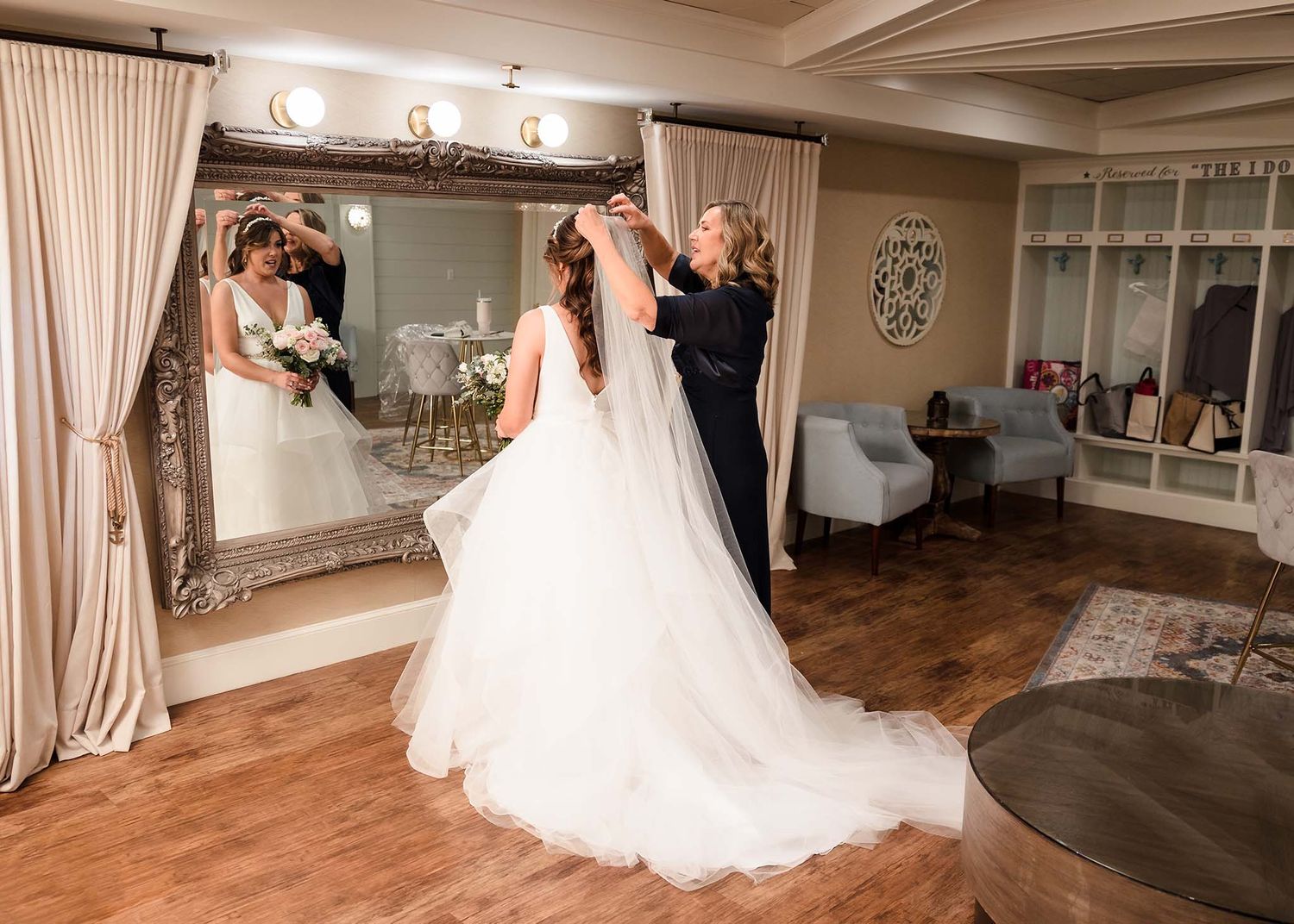 The bride puts the finishing touches on her dress in the bridal suite at the Oceanview of Nahant .
