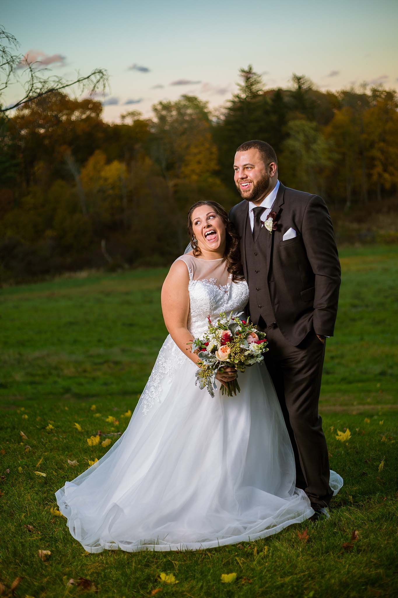 The bride and groom enjoy a laugh while posing for portraits at Peirce Farm Witch Hill