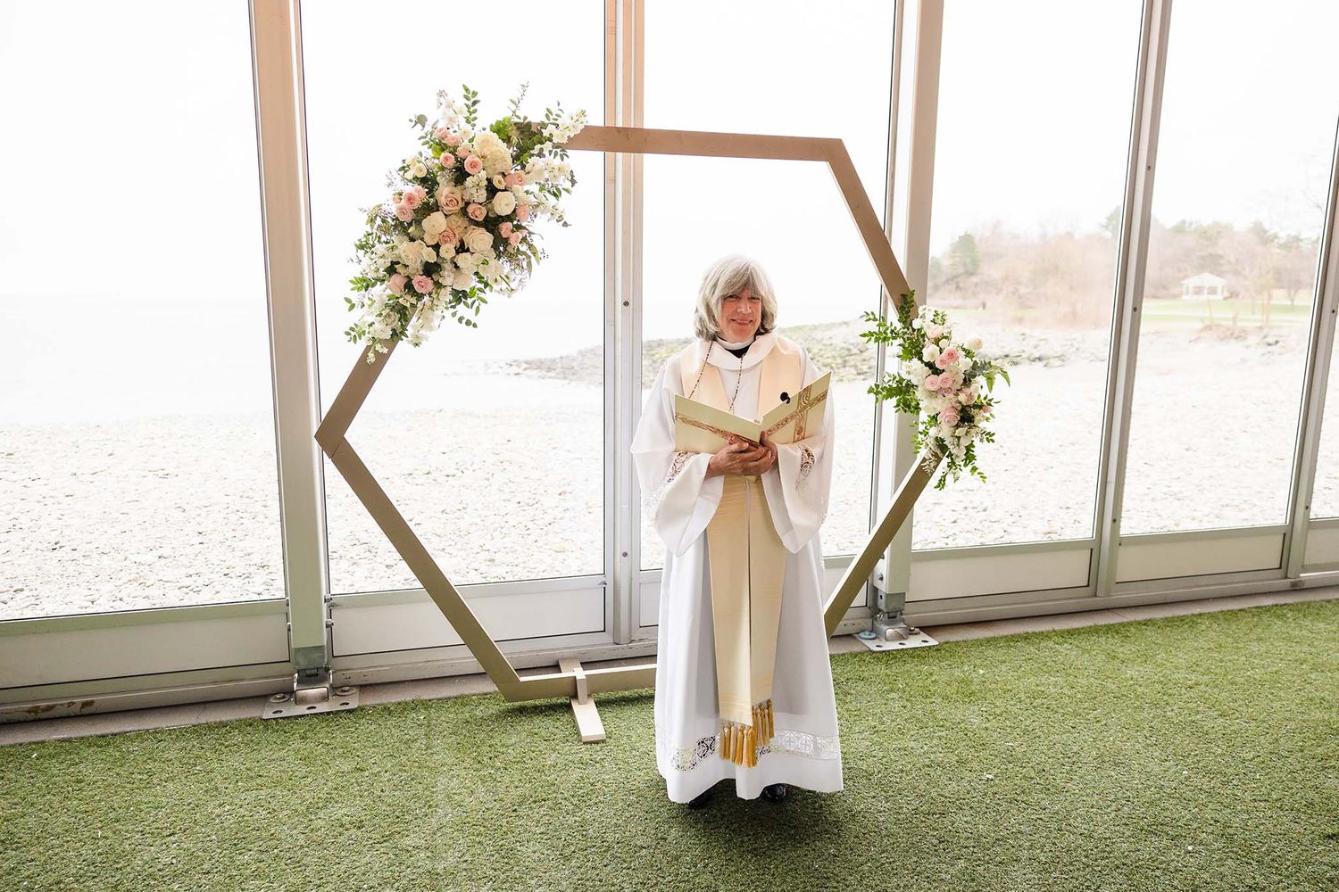 Candid moment where the wedding officiant announces the start of the wedding ceremony.
