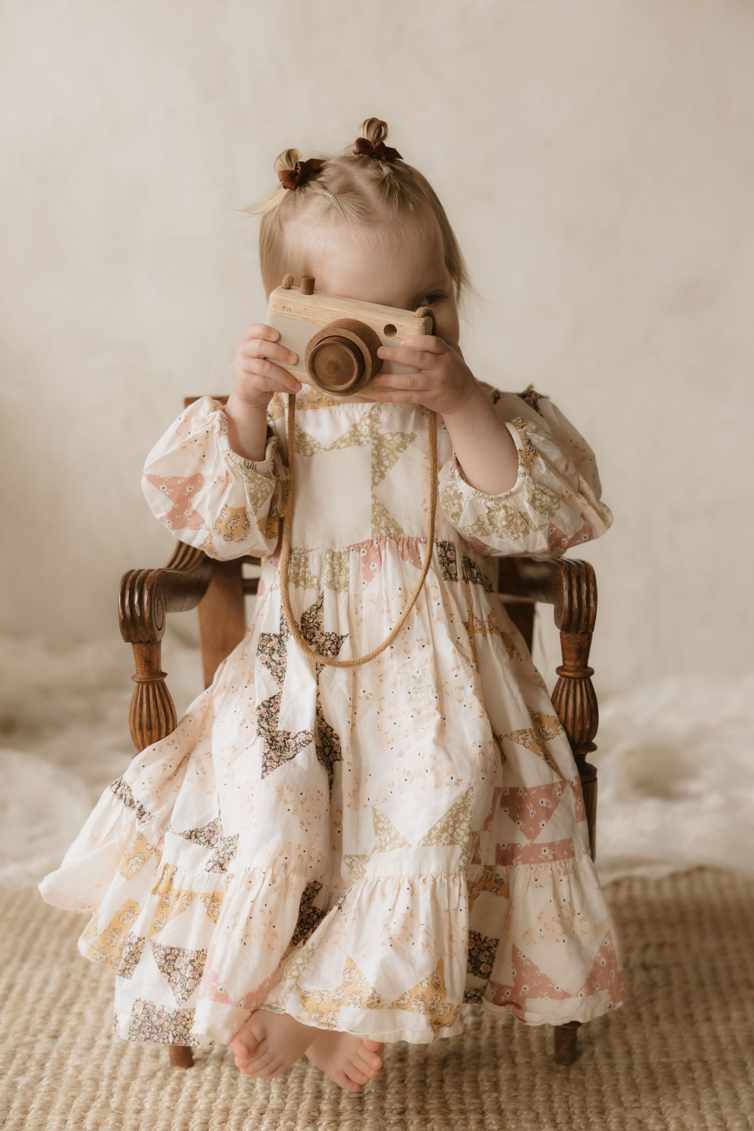 A series of vintage-style photos showing a small child in a delicate lace dress sitting in an antique wooden chair.