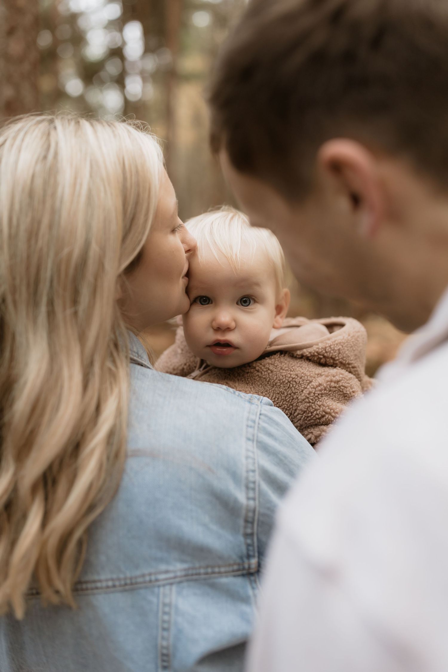 A family shares tender moments in a series of close-up shots showing affection and connection in warm outdoor lighting.