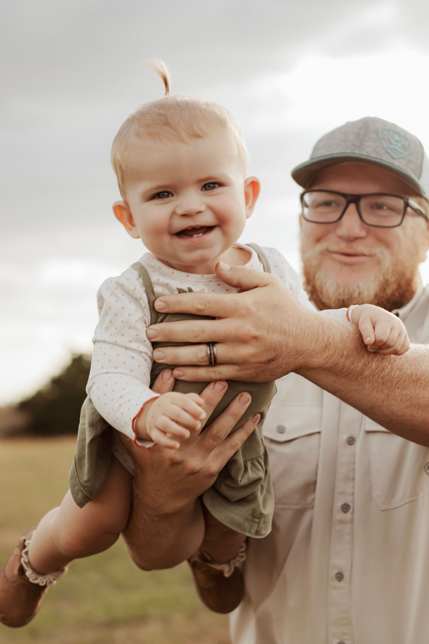 Dad playing with his daughter during an outdoor family session in York, NE