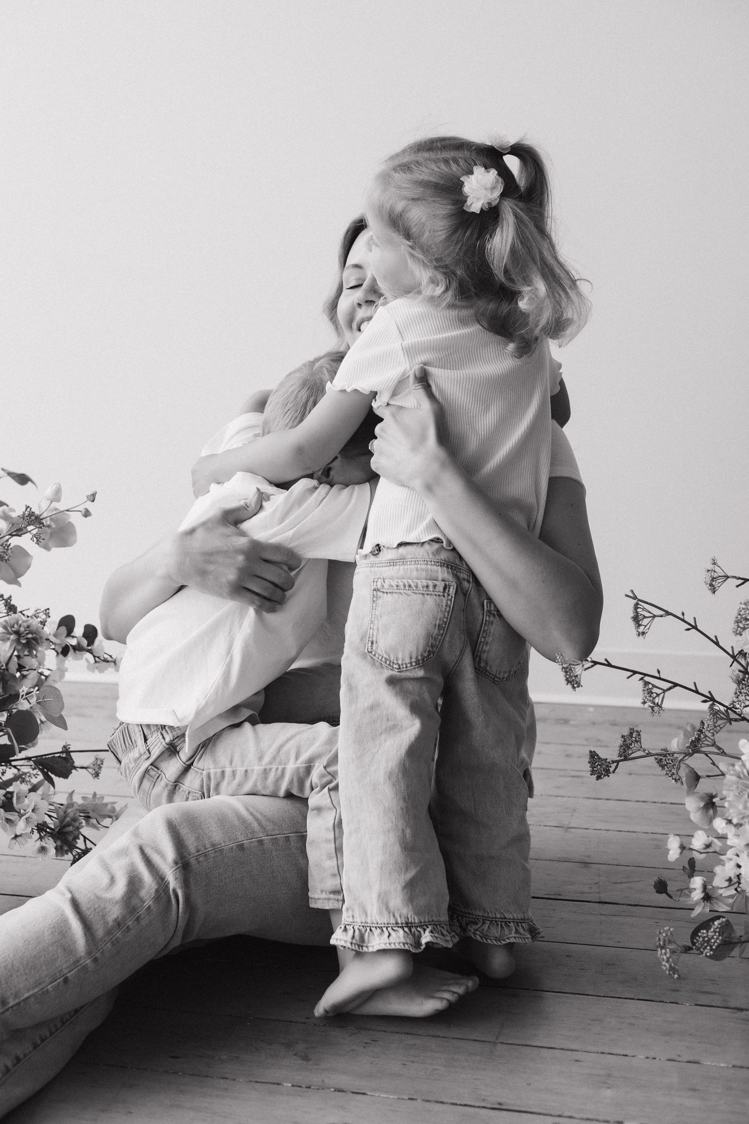 Mom hugging her children during an indoor Mommy and Me studio session