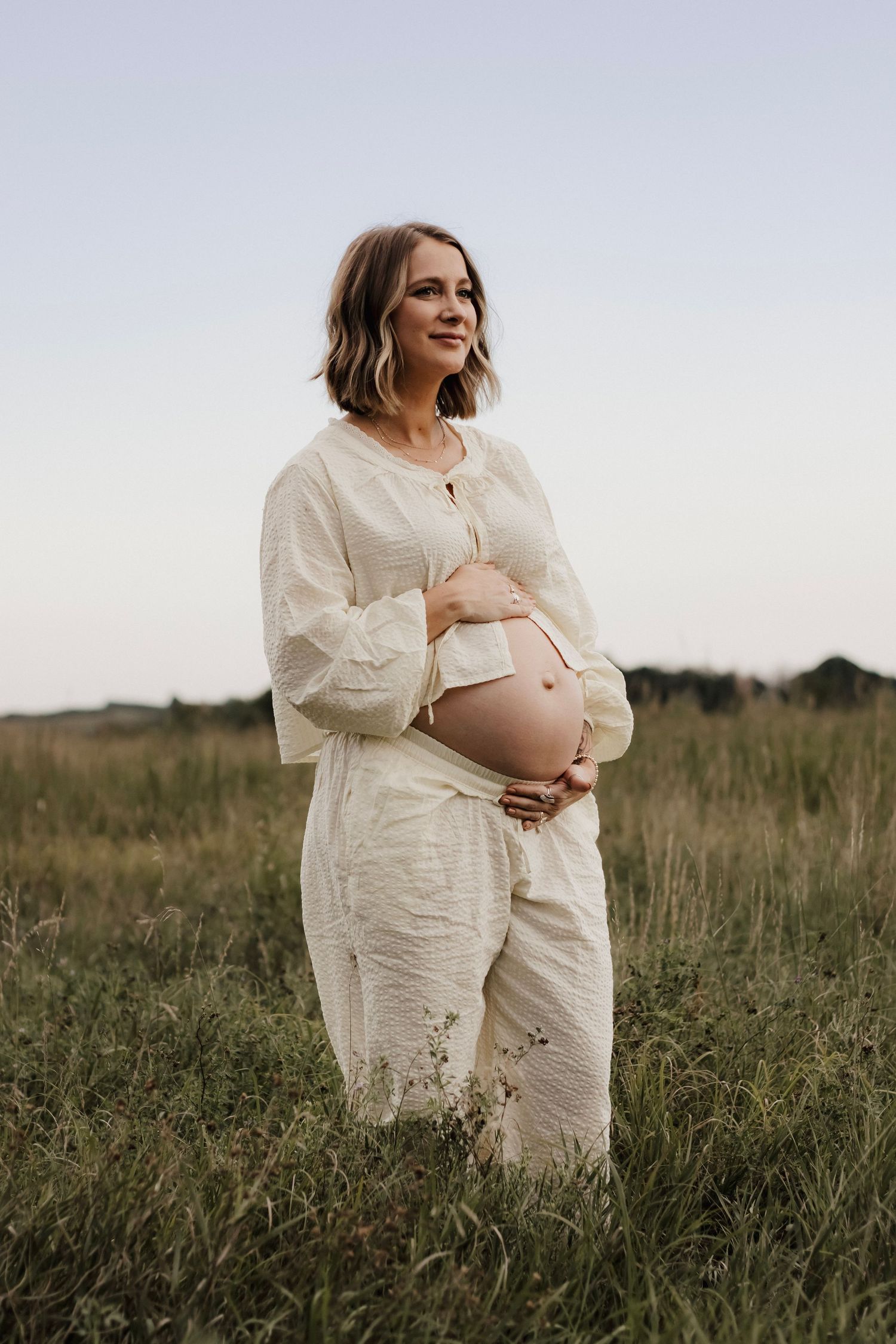 Pregnant mother in a field during maternity photos in Central Nebraska