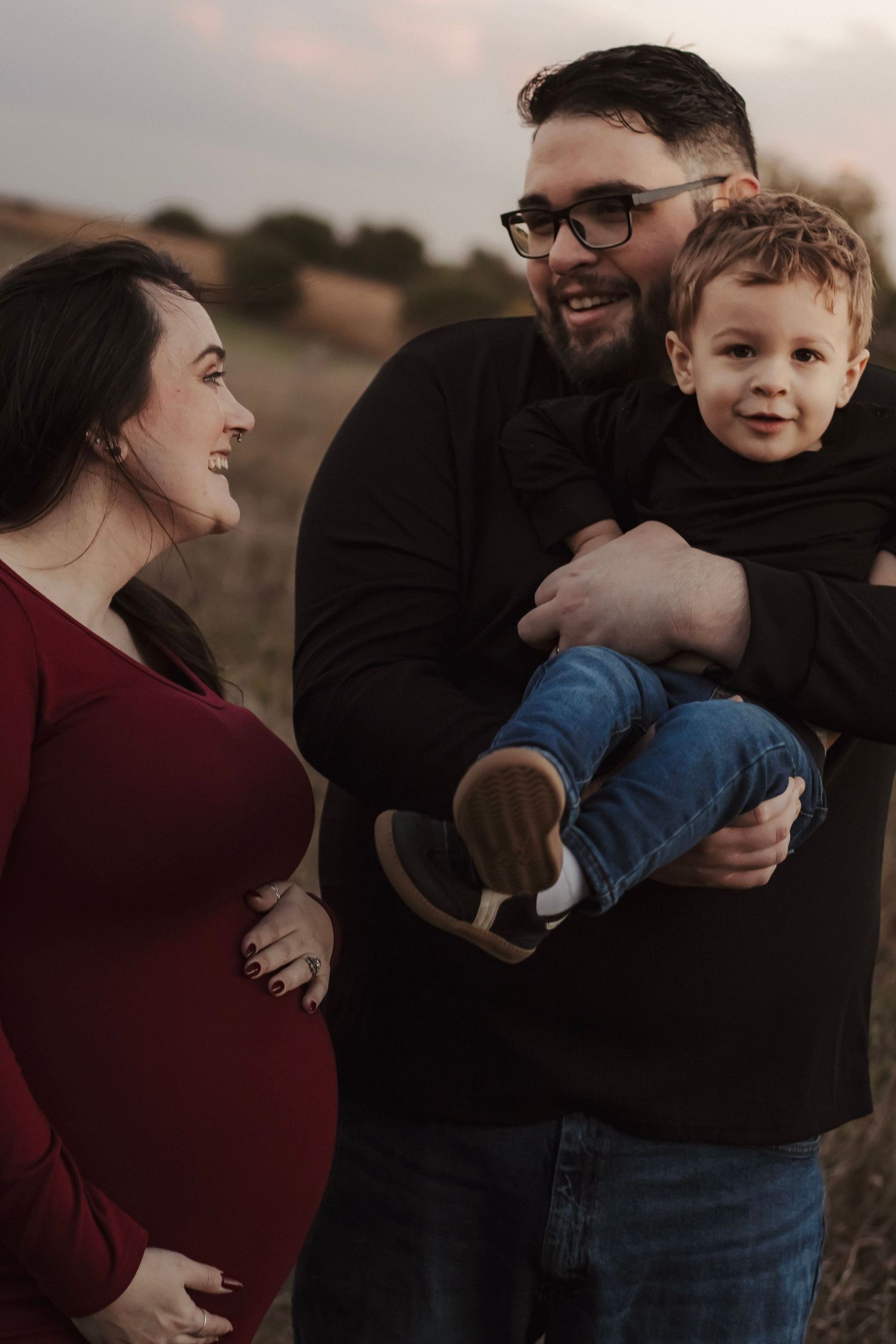 Family of four laughing together during golden hour portraits in York, Nebraska