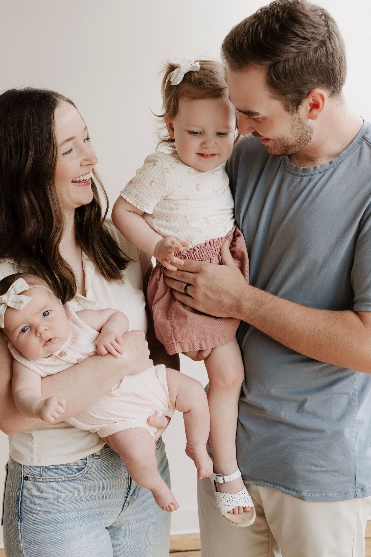 Family laughing together during candid photos in downtown Hastings, Nebraska