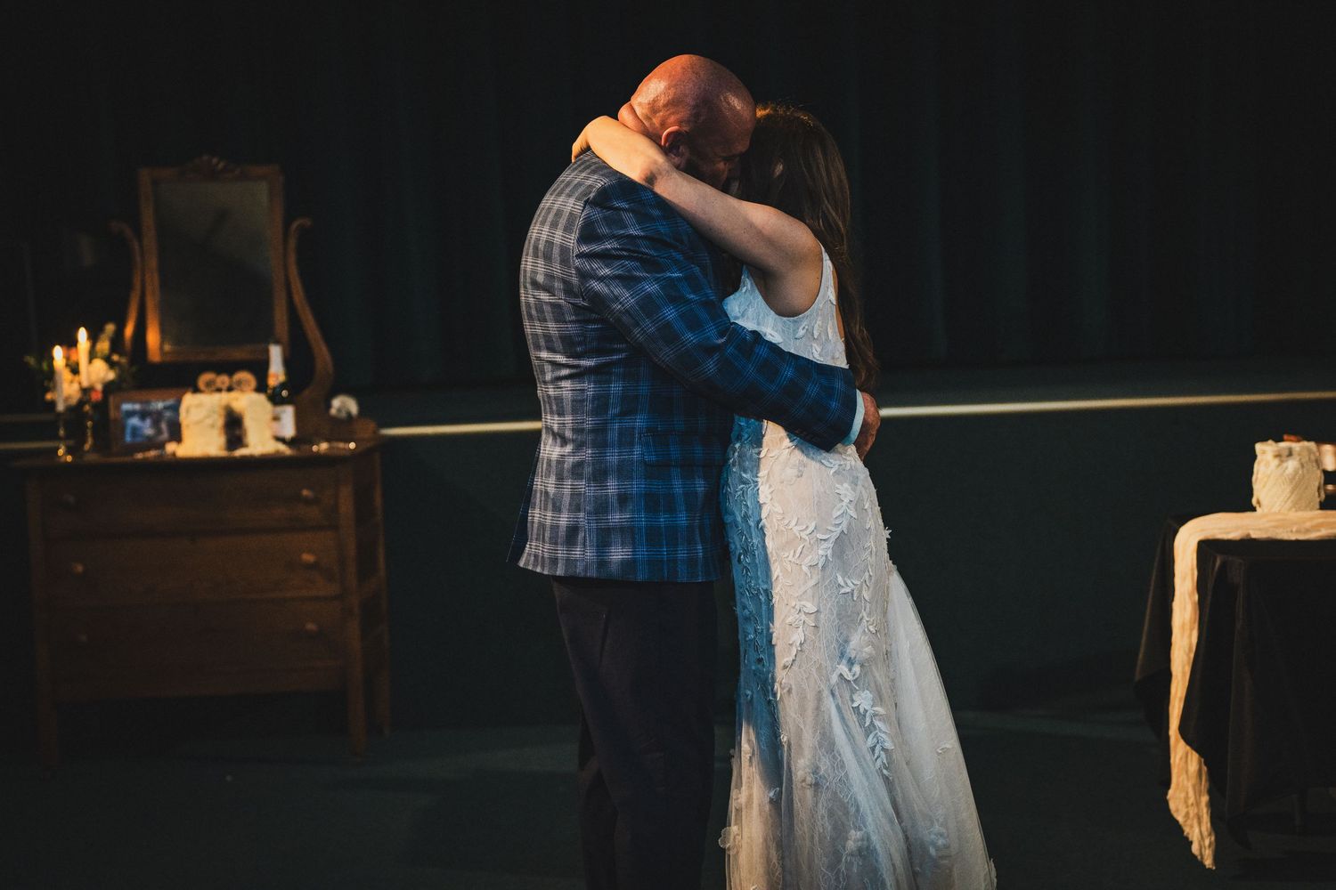 Bride and groom sharing an intimate embrace on the dance floor during their first dance.