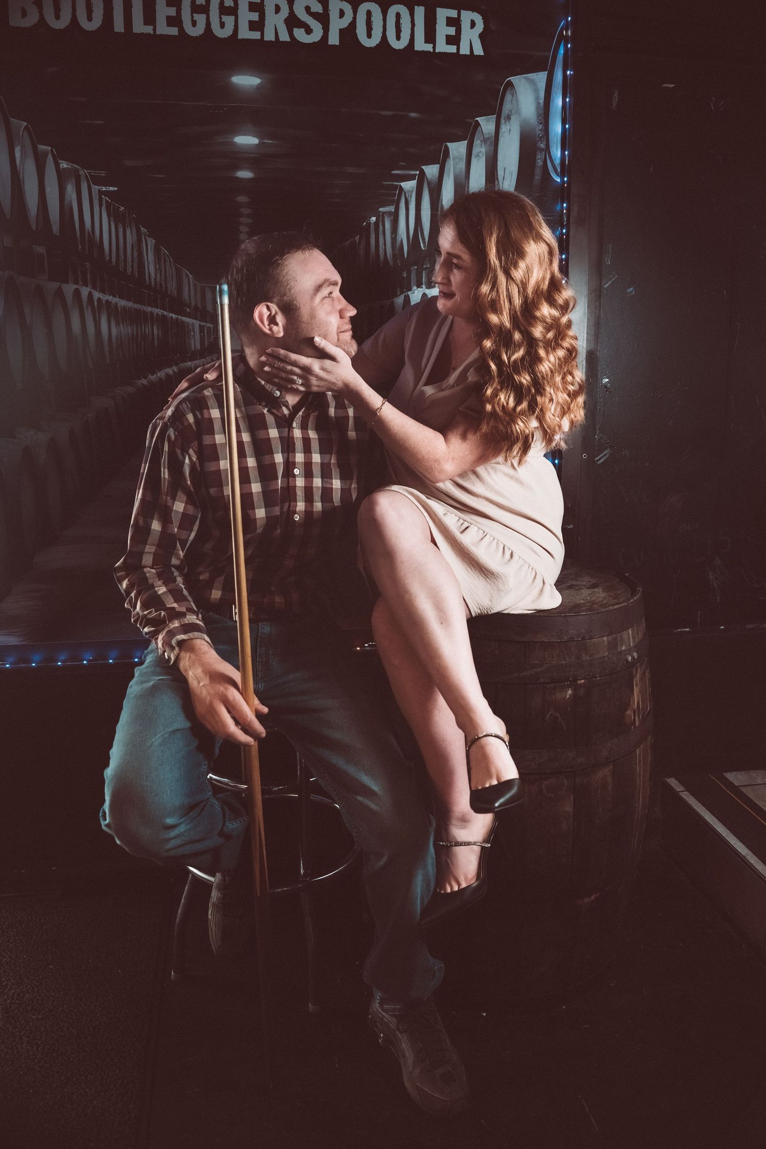 A couple dancing intimately in a dimly lit venue with a dark moody atmosphere.