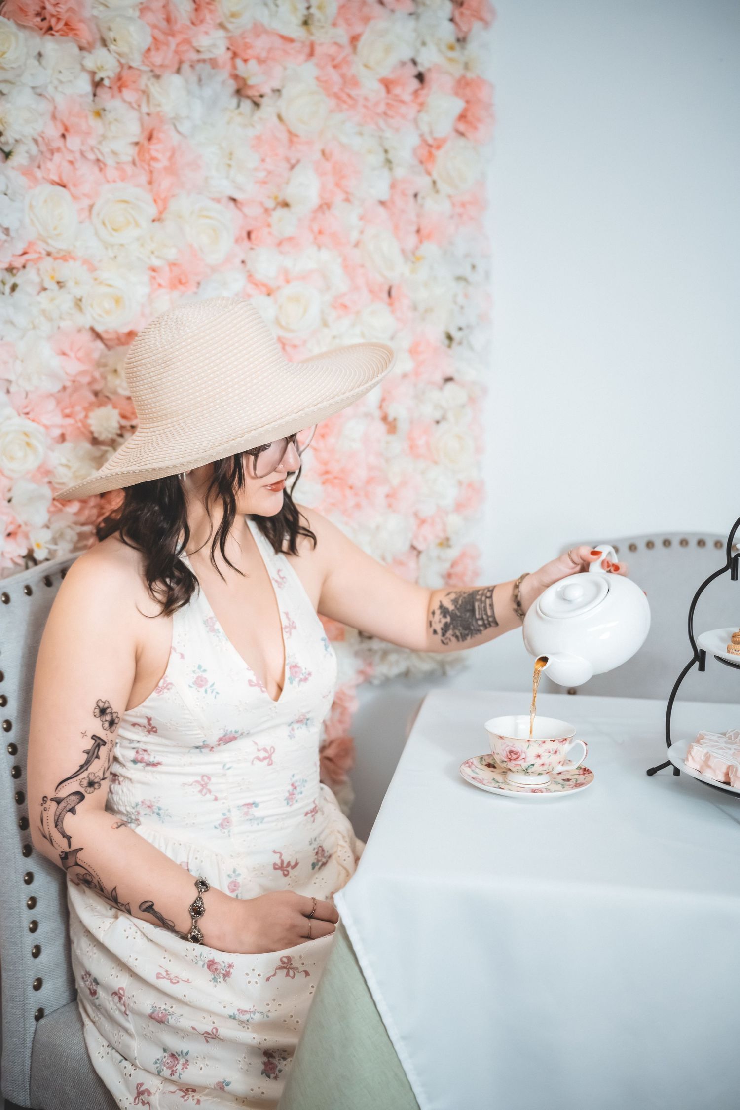 A series of photos showing someone in a white dress eating cake against a pink floral backdrop.