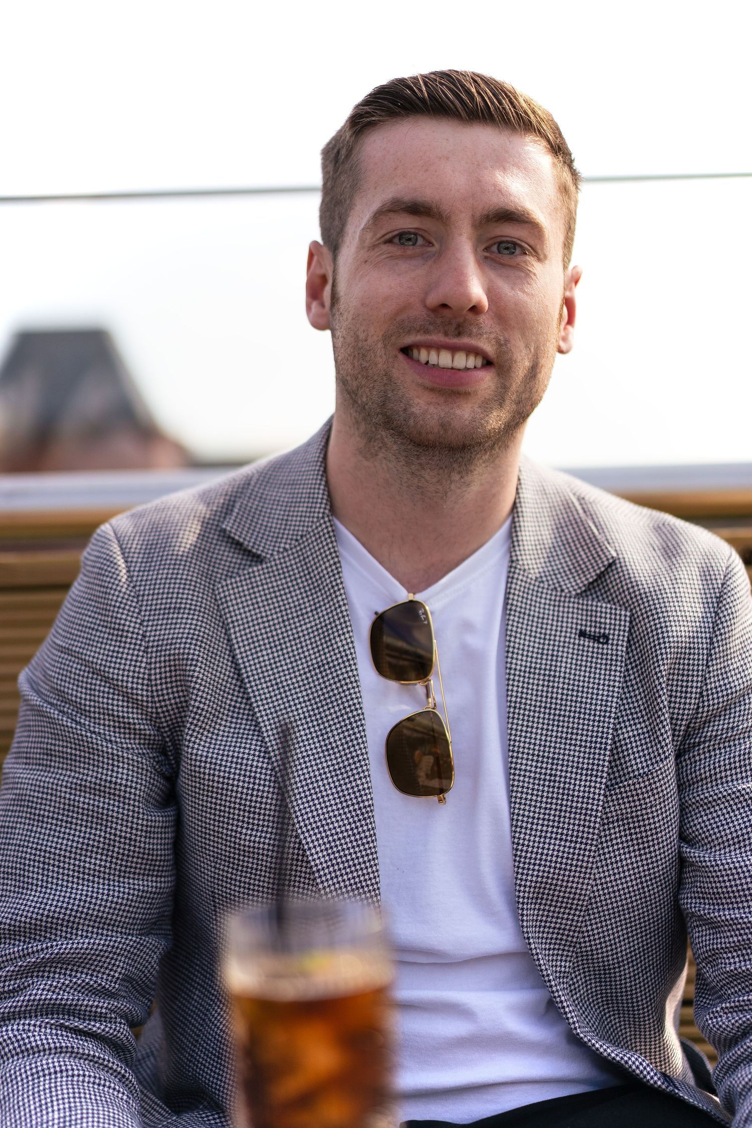 Matt at rooftop cocktail bar in Leeds with guests enjoying drinks at sunset