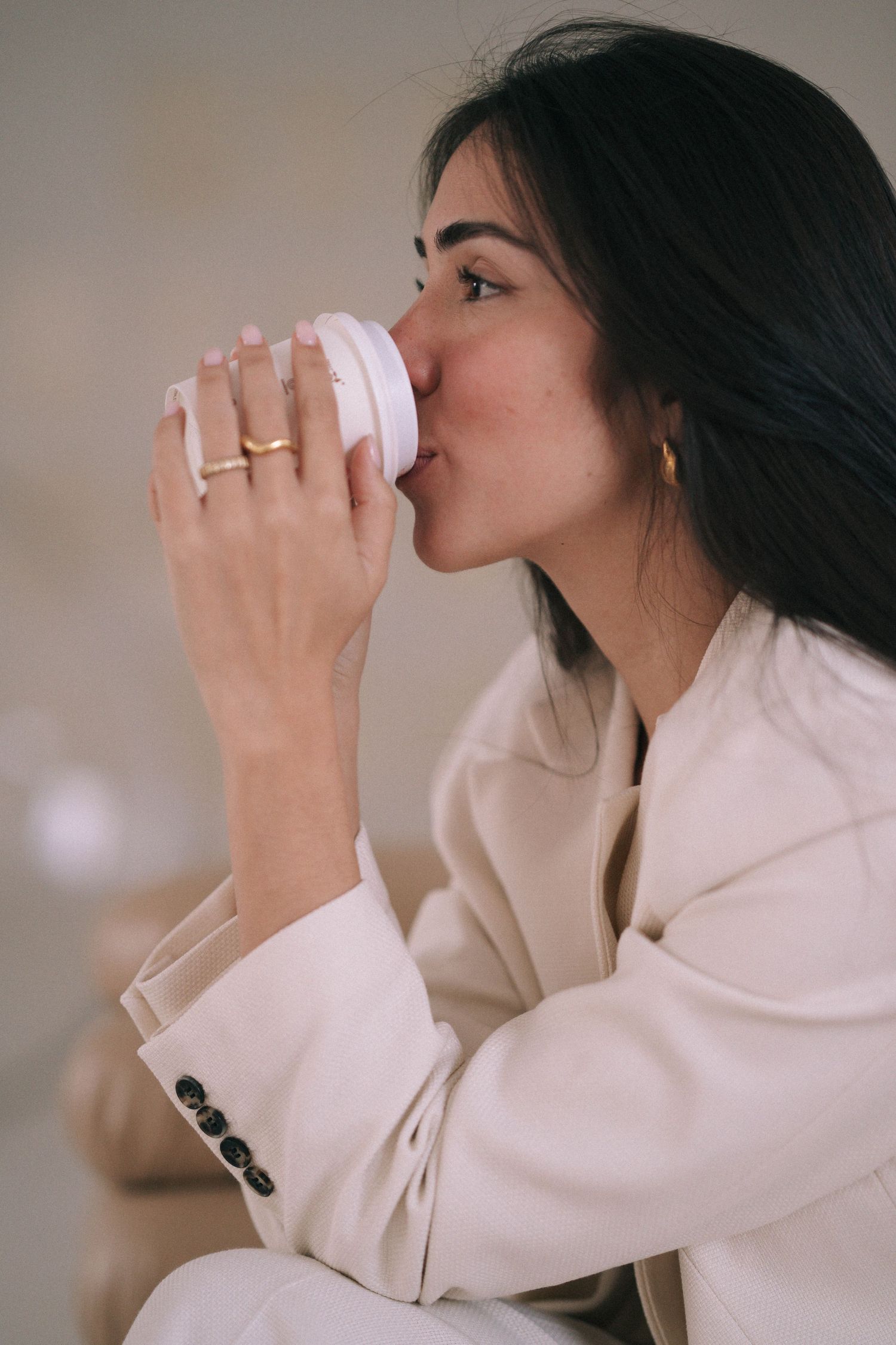 Branding Photography Sessions capture a personal branding photoshoot in Sydney featuring an entrepreneur in a cream blazer sipping coffee.
