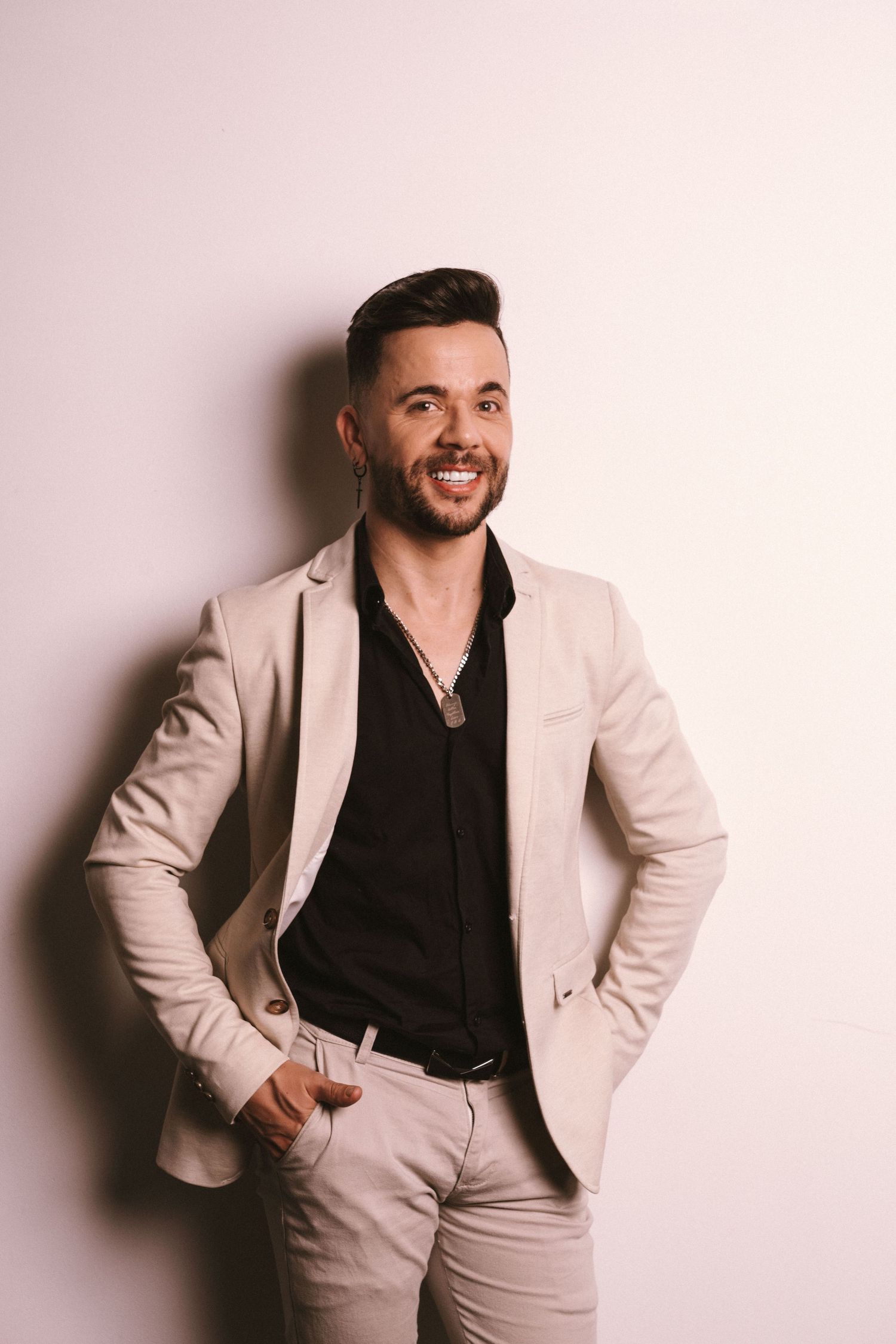 Branding Photography Sessions featuring a stylish person in a beige suit and black shirt, showcasing storytelling brand imagery