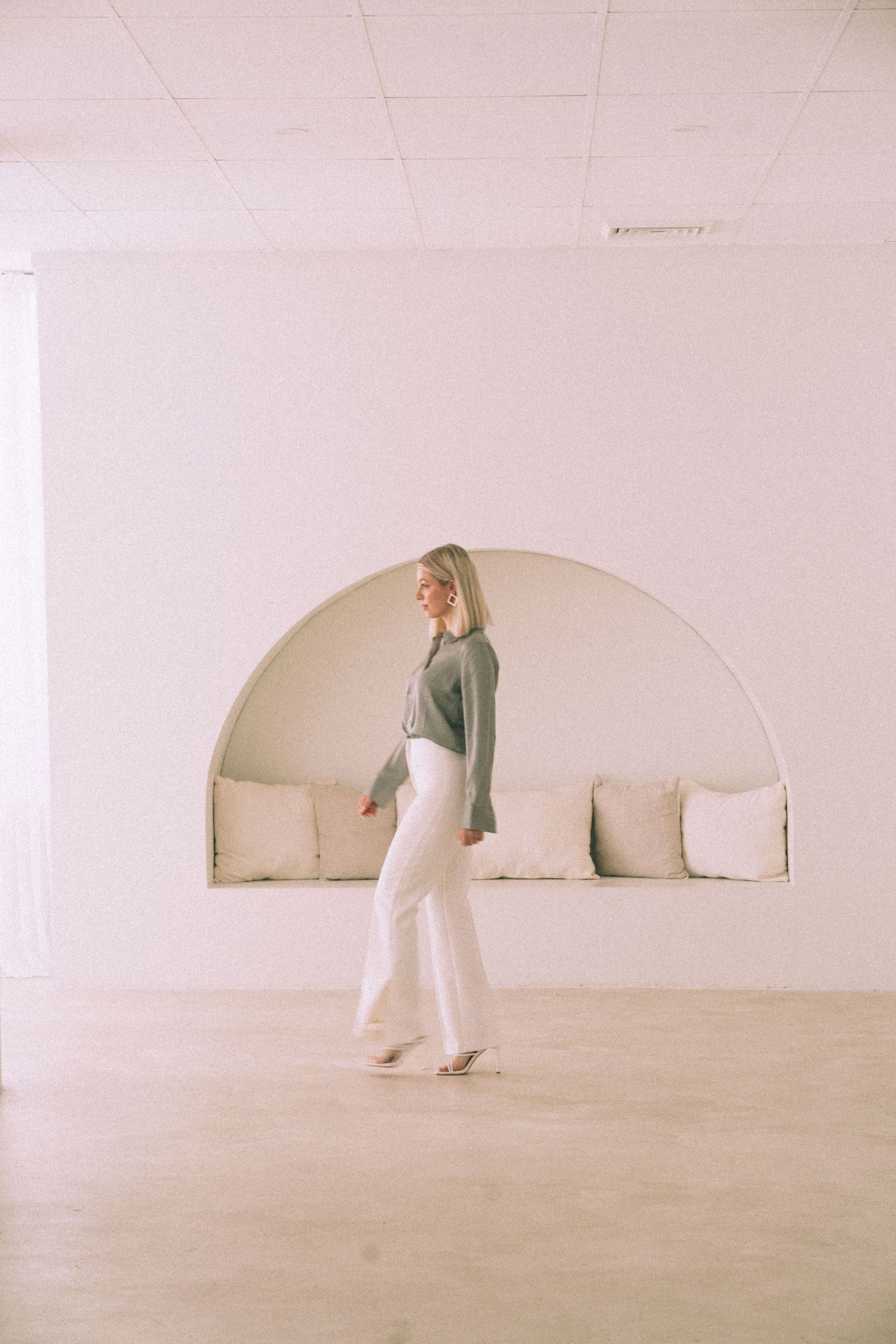 Digital marketing agency personal branding photoshoot in Sydney captures an entrepreneur in white pants and a green sweater.